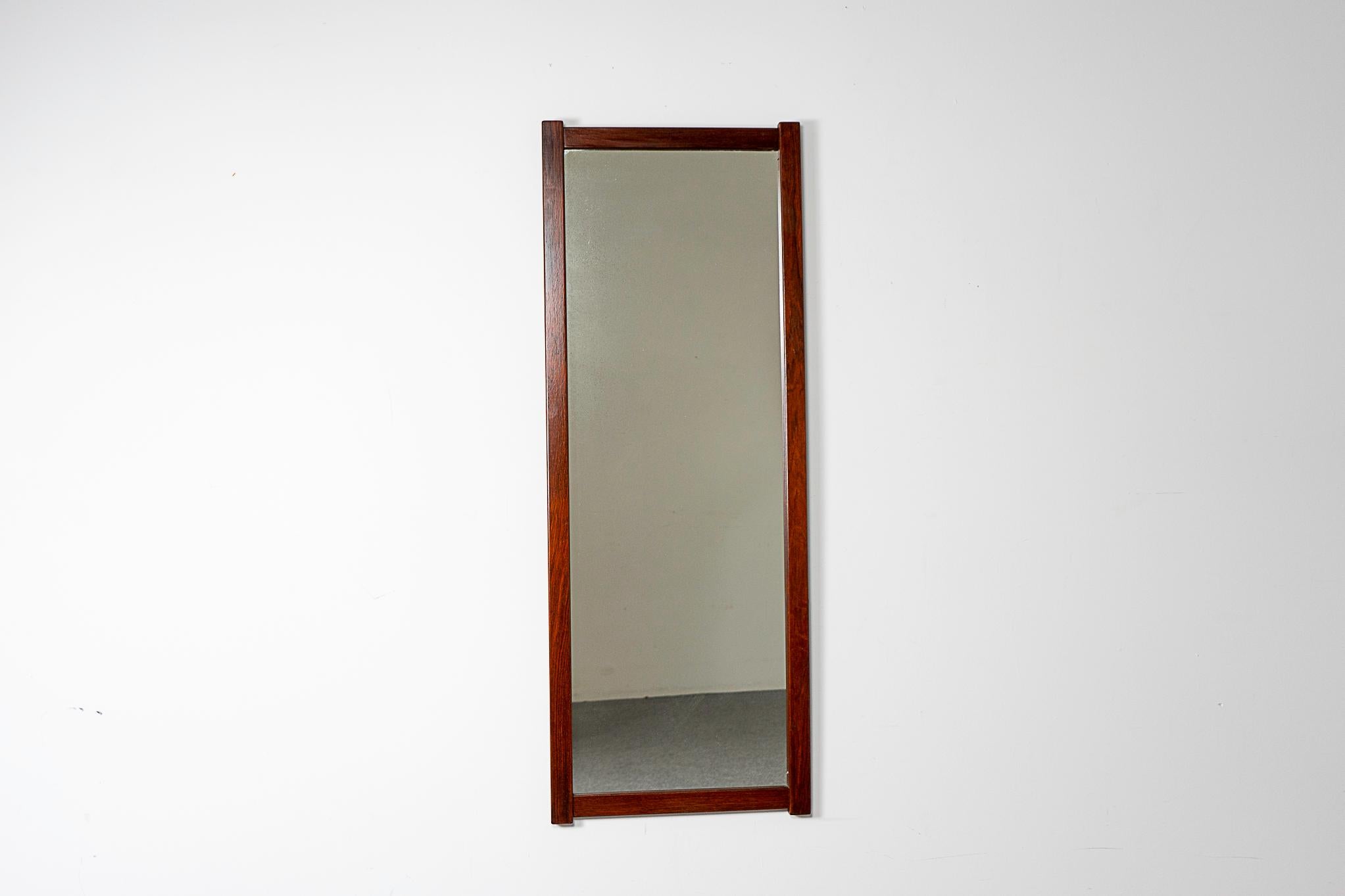 Rosewood mid-century mirror, circa 1960's. Slim design is perfect for hanging near the door to check yourself before heading out!