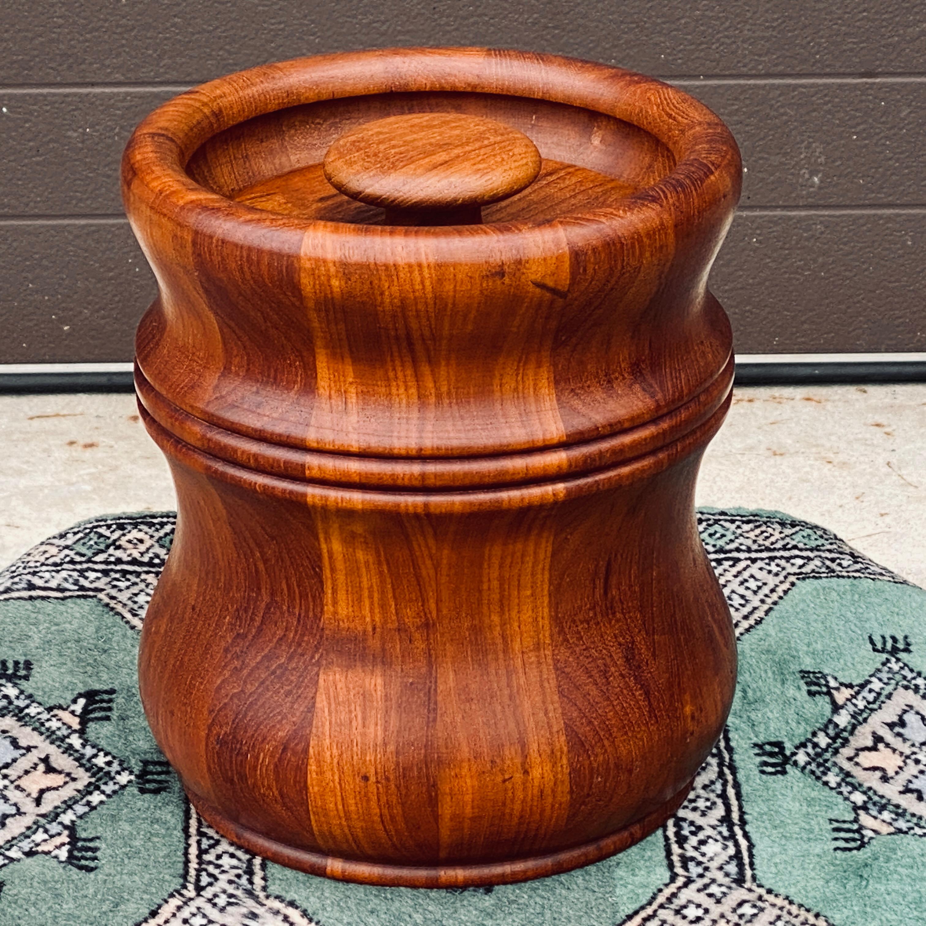 Mid-Century solid teak lidded ice bucket by Richard Nissen, Denmark. This piece displays a unique sculptural and heavily turned shape and has the original black plastic liner intact. Maker's mark on underside.