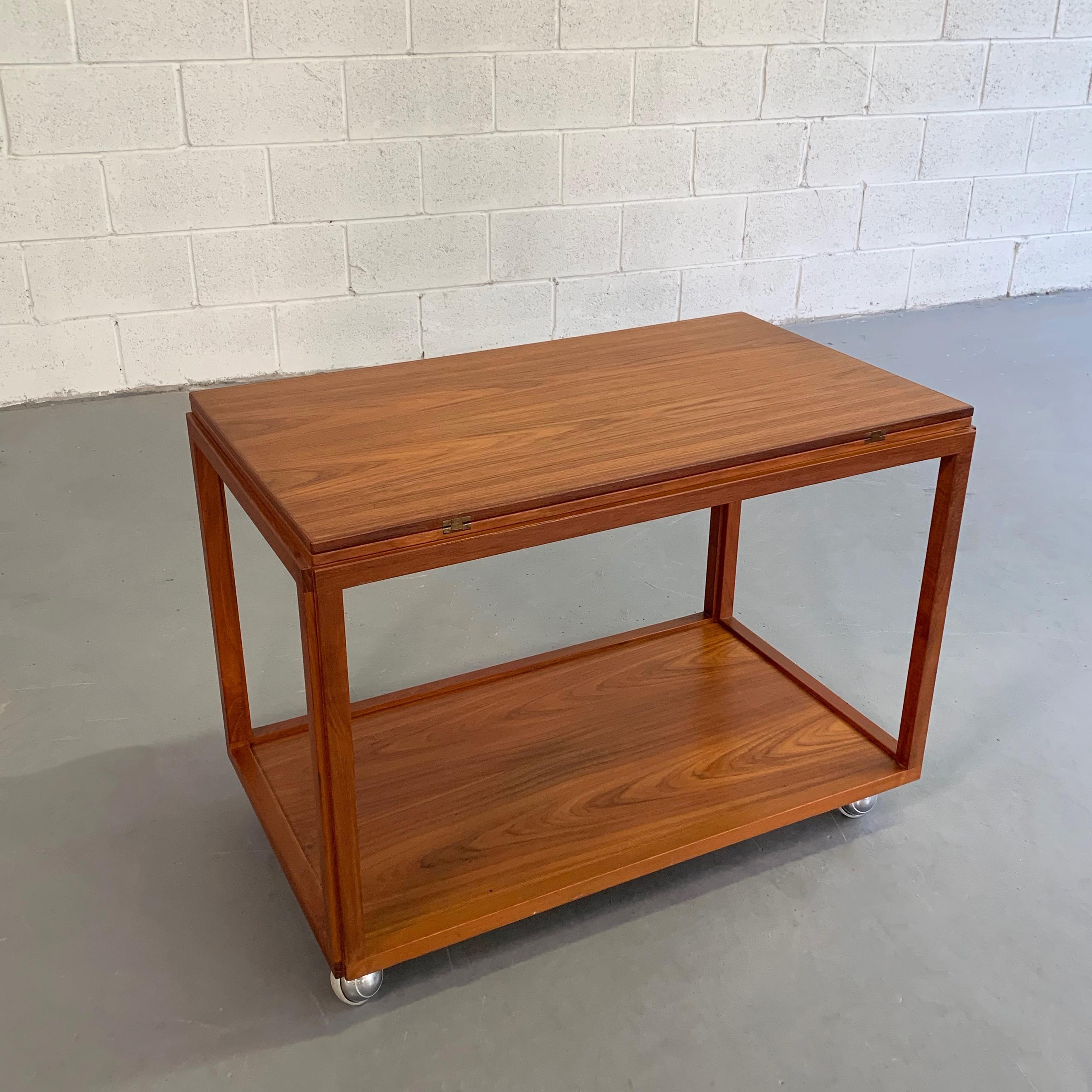 Multipurpose, Danish modern, rolling, teak side table or serving bar cart features an expanding top that swivels open to 38 x 32 inches with beautifully detailed joinery.
