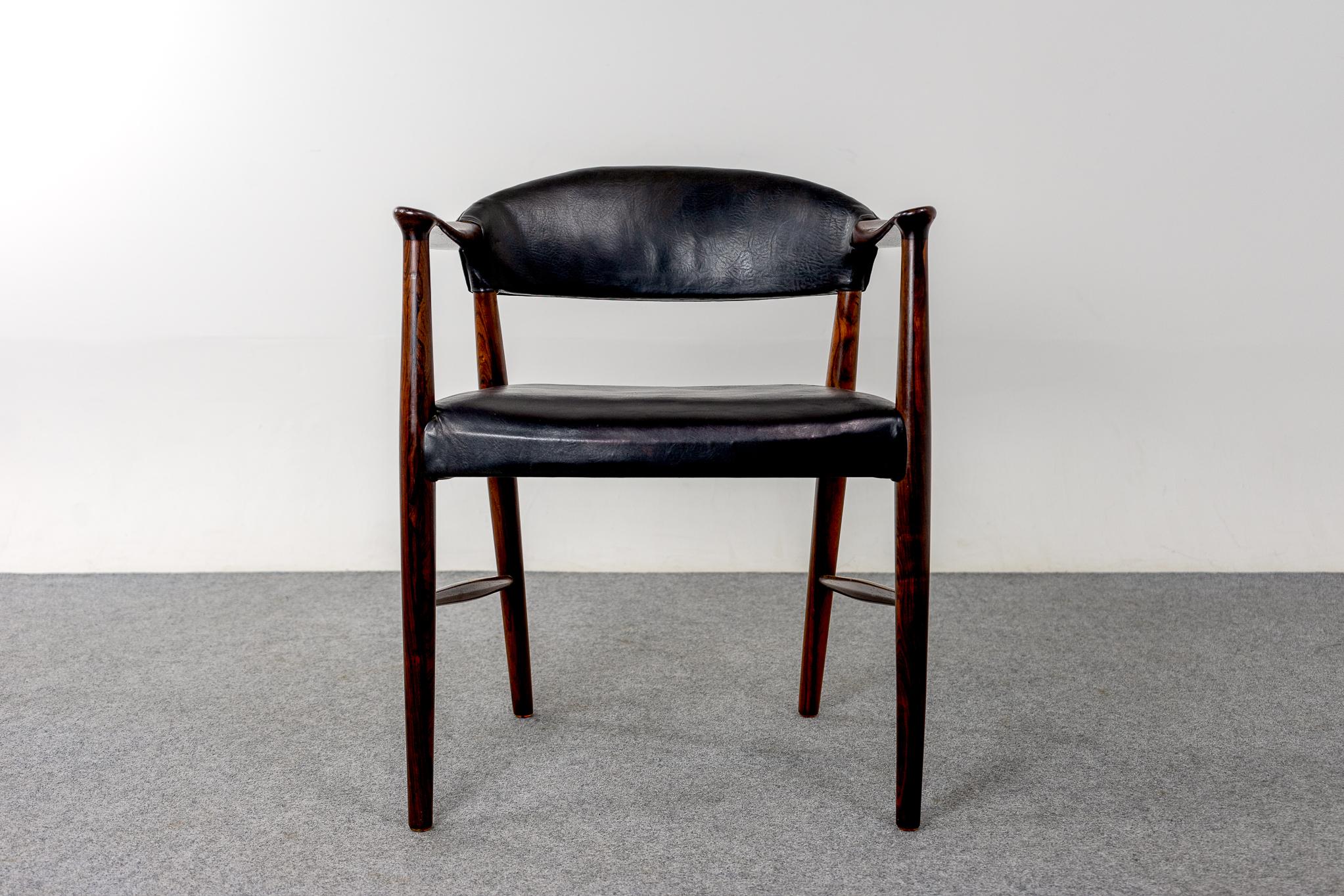 Rosewood and leather Danish armchair by Kurt Olsen, circa 1960's. Sturdy solid wood frame with stunning grain patterning on the sculpted frame. Comfort without an imposing footprint! 

Please inquire for remote and international shipping.