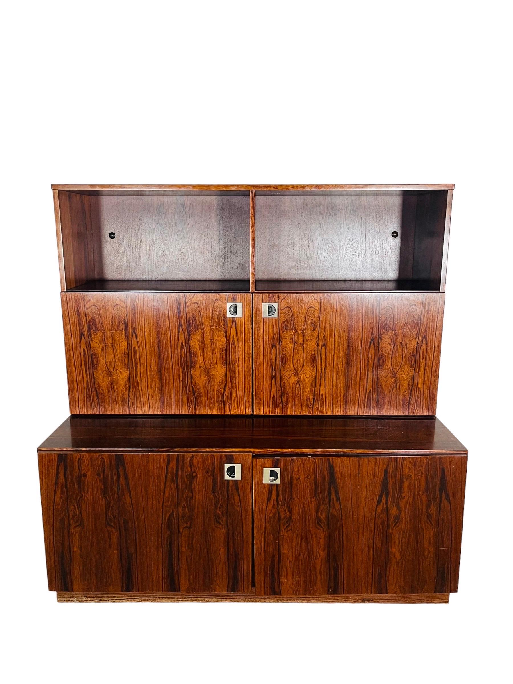 Beautiful Danish Modern rosewood bar cabinet by Hammel Mobelfabrik. This beautiful rosewood piece can be used as a cabinet with plenty of storage space. Behind the right upper door there is a mirror on the back panel which a light. This piece is in