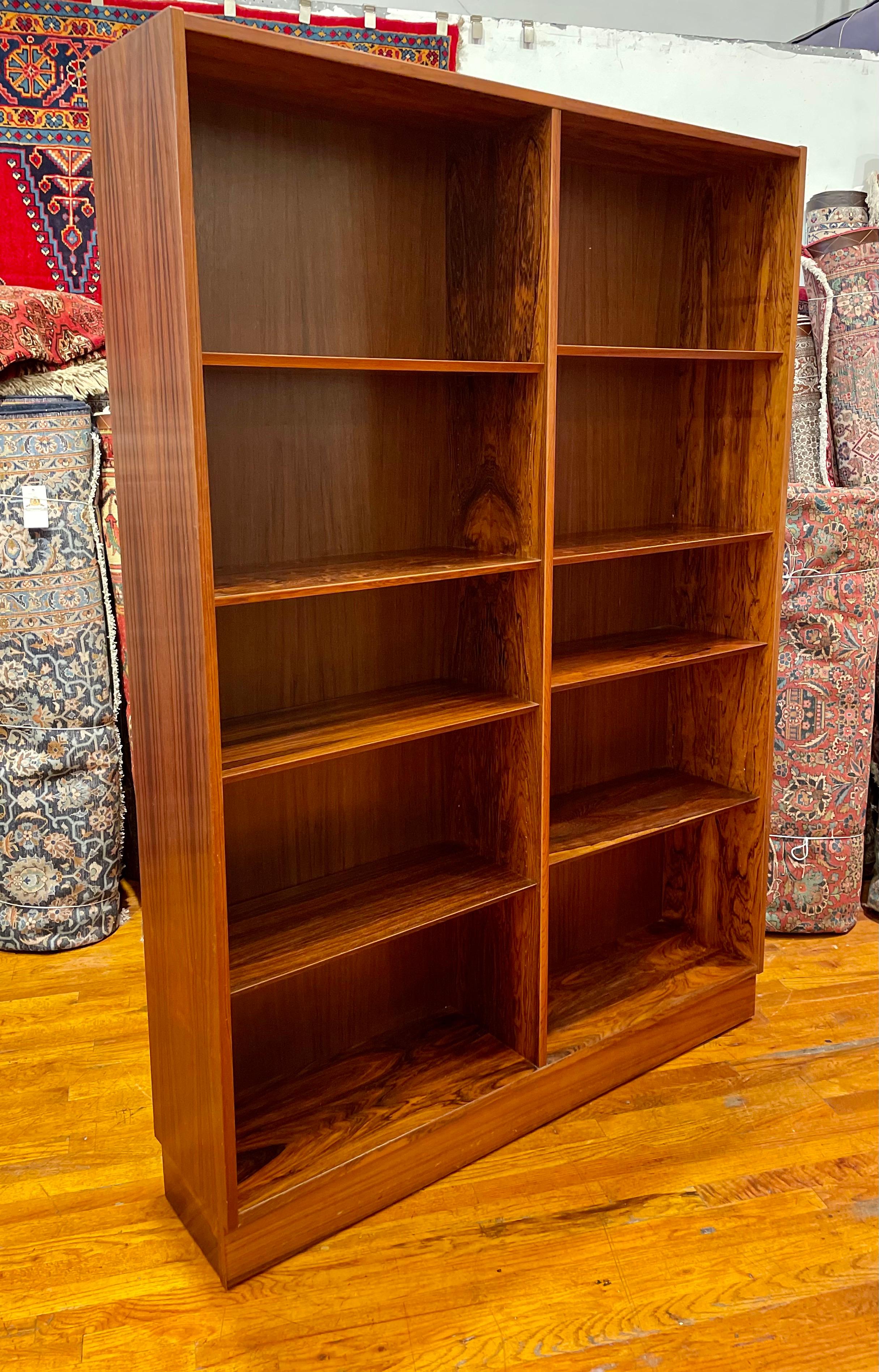 Beautiful elegant rosewood Danish large bookcase, circa 1960's design by Poul Hundevad beautiful grain, nice beveled edge multiple adjustable shelves, nice clean original condition with stamped in the back.
