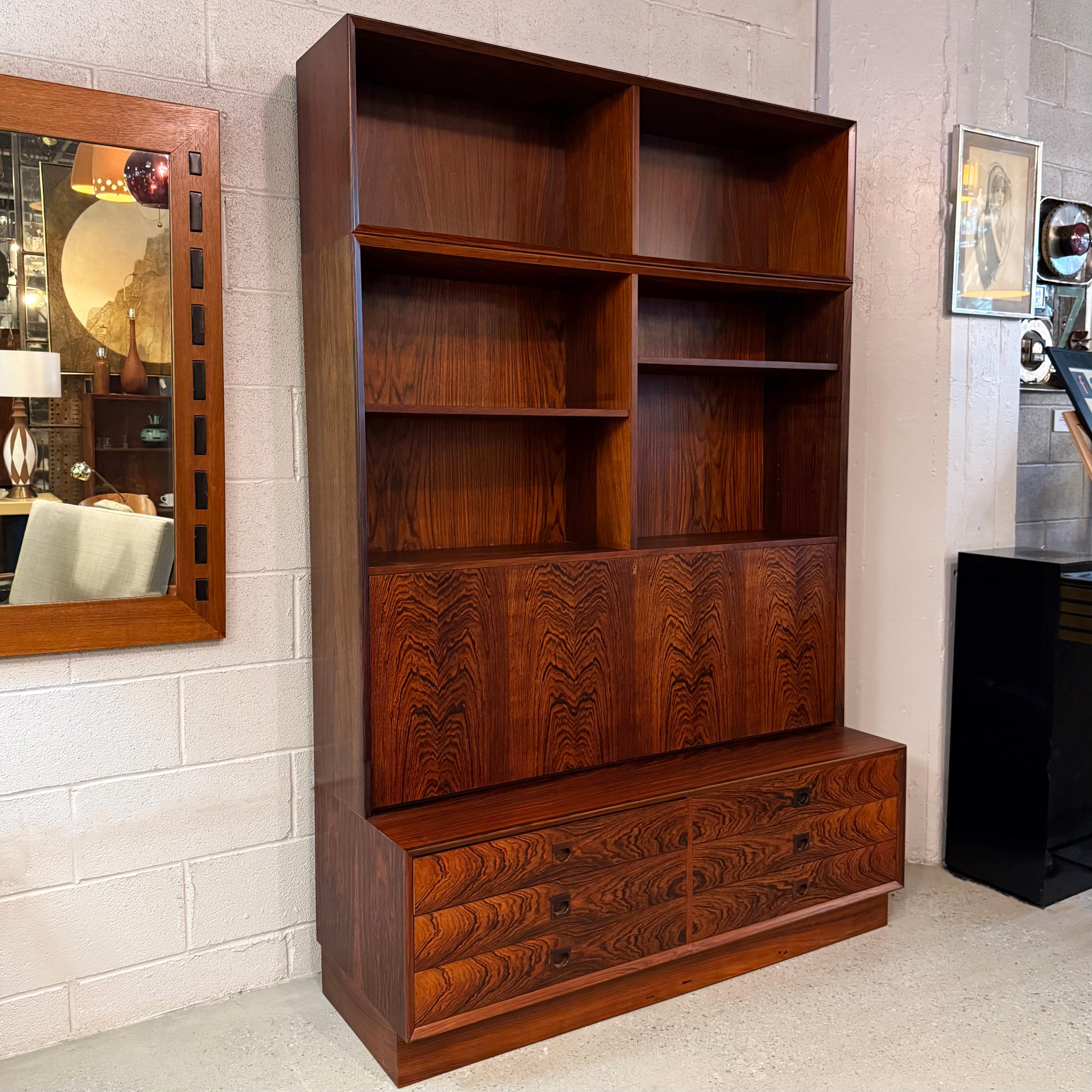 This exquisite midcentury Danish Modern rosewood bookcase cabinet was designed by the Danish designer Erik Brouer for Brouer Møbelfabrik in the 1960s. The rich rosewood grain instantly elevates any space, bringing a sense of warmth and