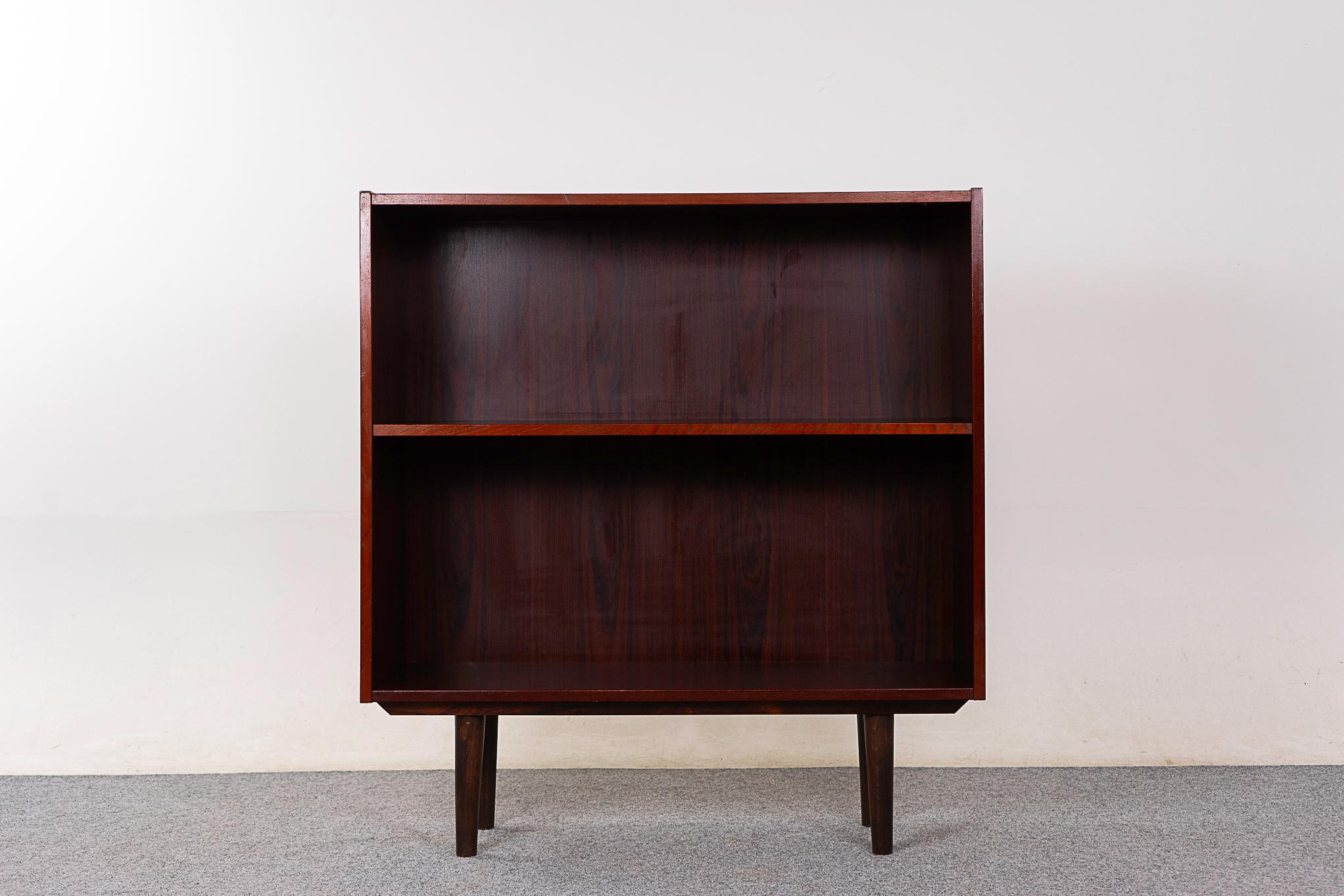 Rosewood Danish bookcase, circa 1960's. Lovely graining, height adjustable shelf with 5 hanging options. Removable tapered legs. Nice as is condition!

Unrestored item with option to purchase in restored condition for an additional $150 USD.