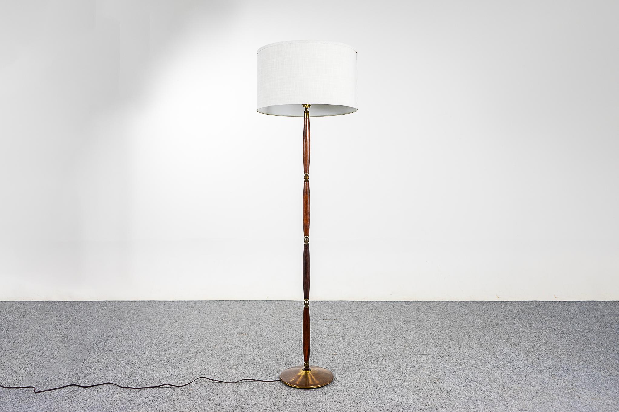 Rosewood & brass Danish floor lamp, circa 1960's. Beautiful solid rosewood construction with metal base and accents Custom quality fabric shade. New tri-light socket allows for 3 brightness levels, rewired for 110V. Light up your life!

Please