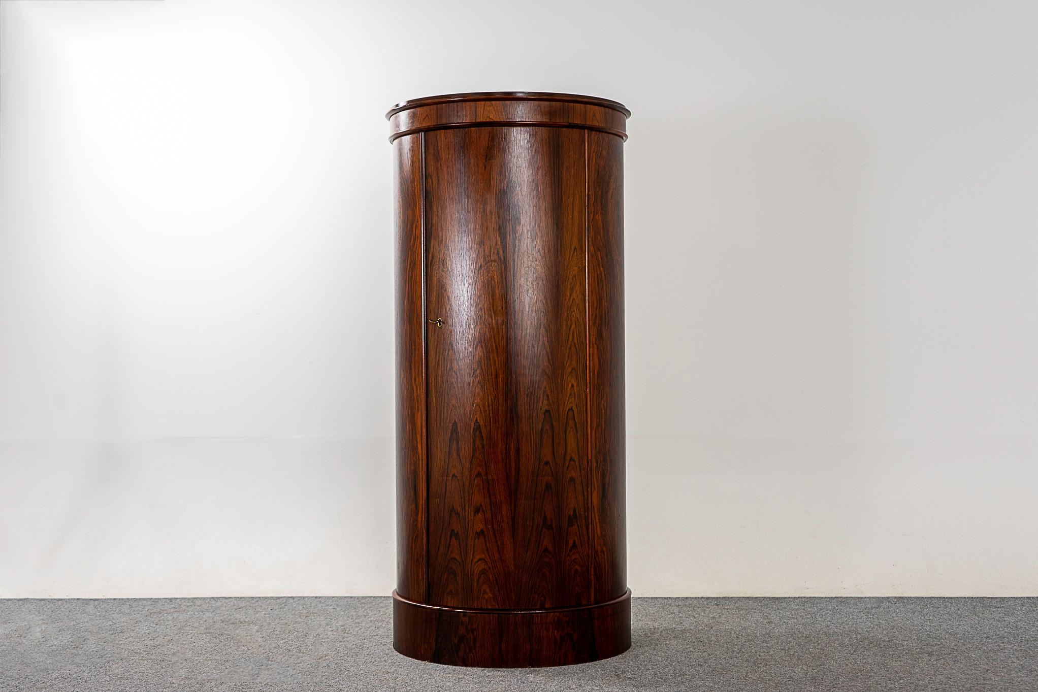 Rosewood Danish cabinet by Johannes Sorth, circa 1960s. Beautiful barrel shaped locking door opens up to reveal adjustable shelving. Date stamped May 22, 1967, makers' mark intact. Minor veneer loss along edges.