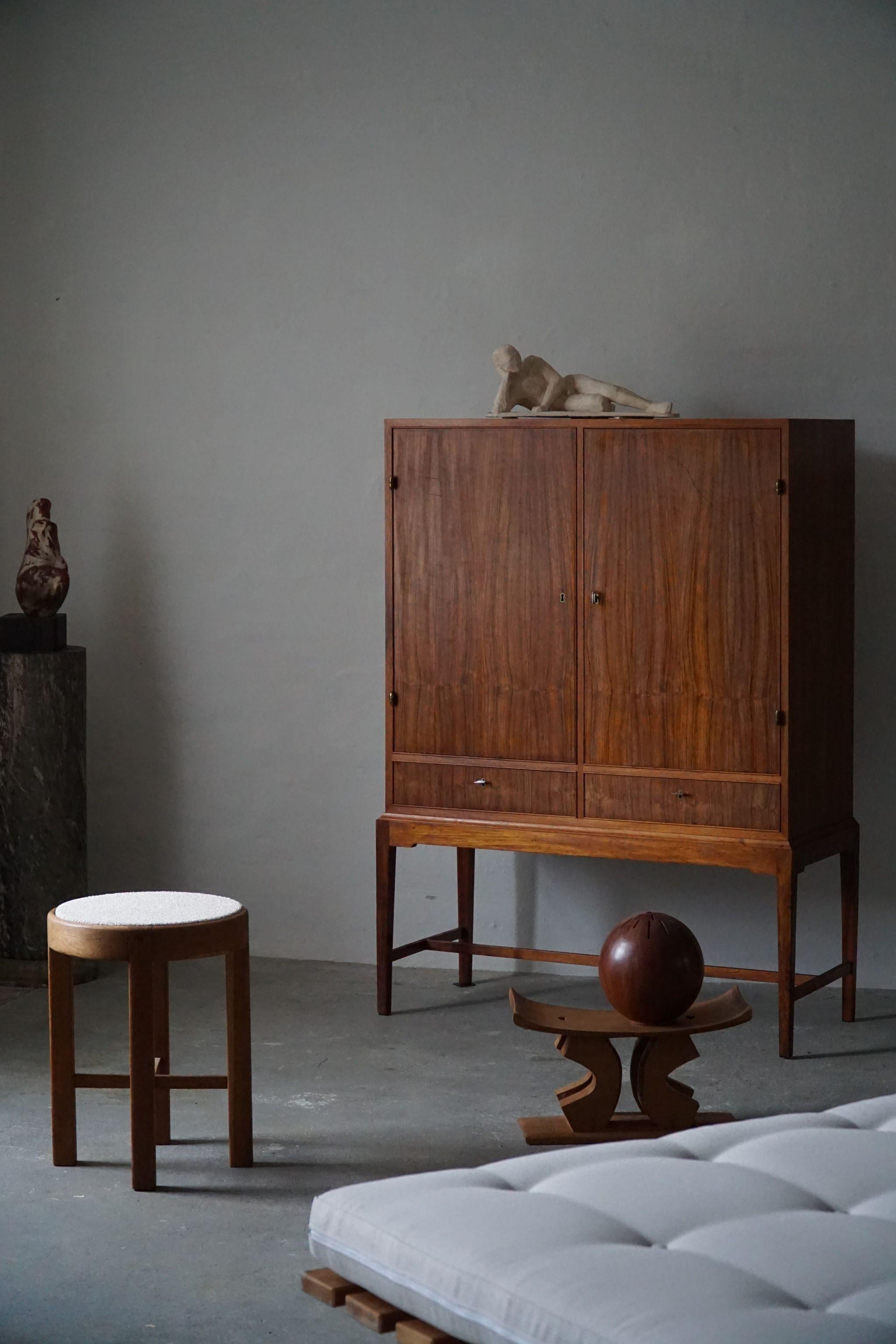 Rare rosewood cabinet, made by a Danish Cabinetmaker in 1940s. Lovely veener work in this elegant object. Made in the style of Ole Wanscher for A.J. Iversen.

The overall impression is really good in this vintage piece.

With a heavy focus on