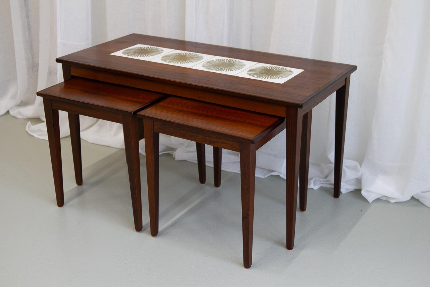 Danish Modern Rosewood & Ceramic Tile Nesting Tables, 1960s, Set of 3.
Nest of three rosewood tables by Kvalitet, Form & Funktion, Denmark. One large table, and two identical smaller tables that fit under the large one. The large table features four