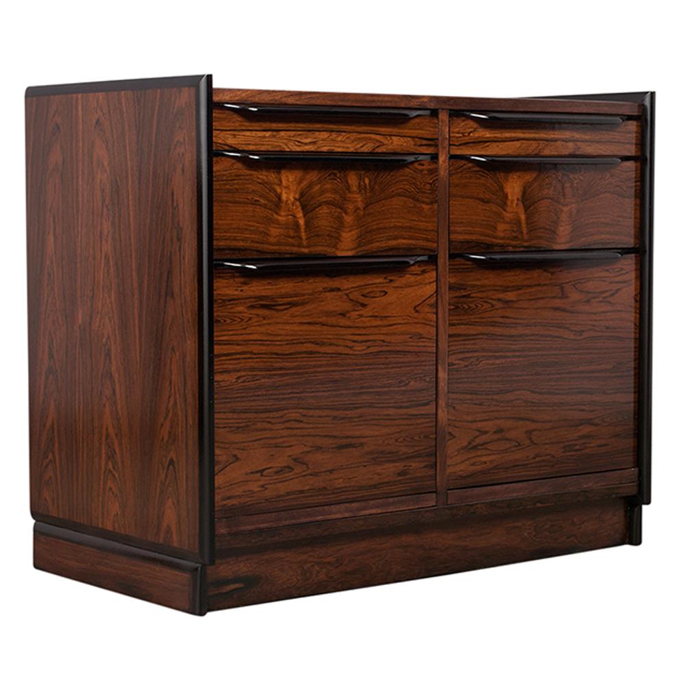This 1950's Mid-Century Modern Chest of Drawers has been completely restored, is stained a rich rosewood and black color combination with a newly lacquered finish. The dresser features four small top drawers and two deep bottom drawers with long