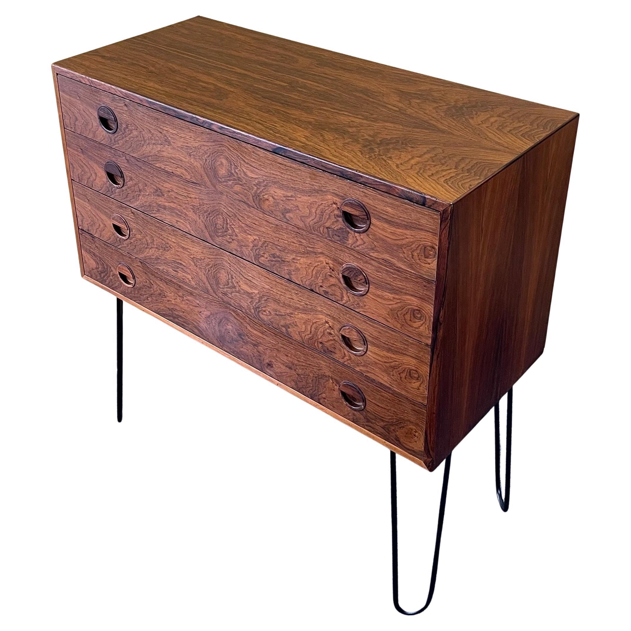 Beautiful and elegant Danish modern chest of drawers on hairpin legs, circa 1960s. The chest is in good vintage condition and has wonderful graining in the rosewood. It has four drawers with double handles and sits on four iron hairpin legs. The