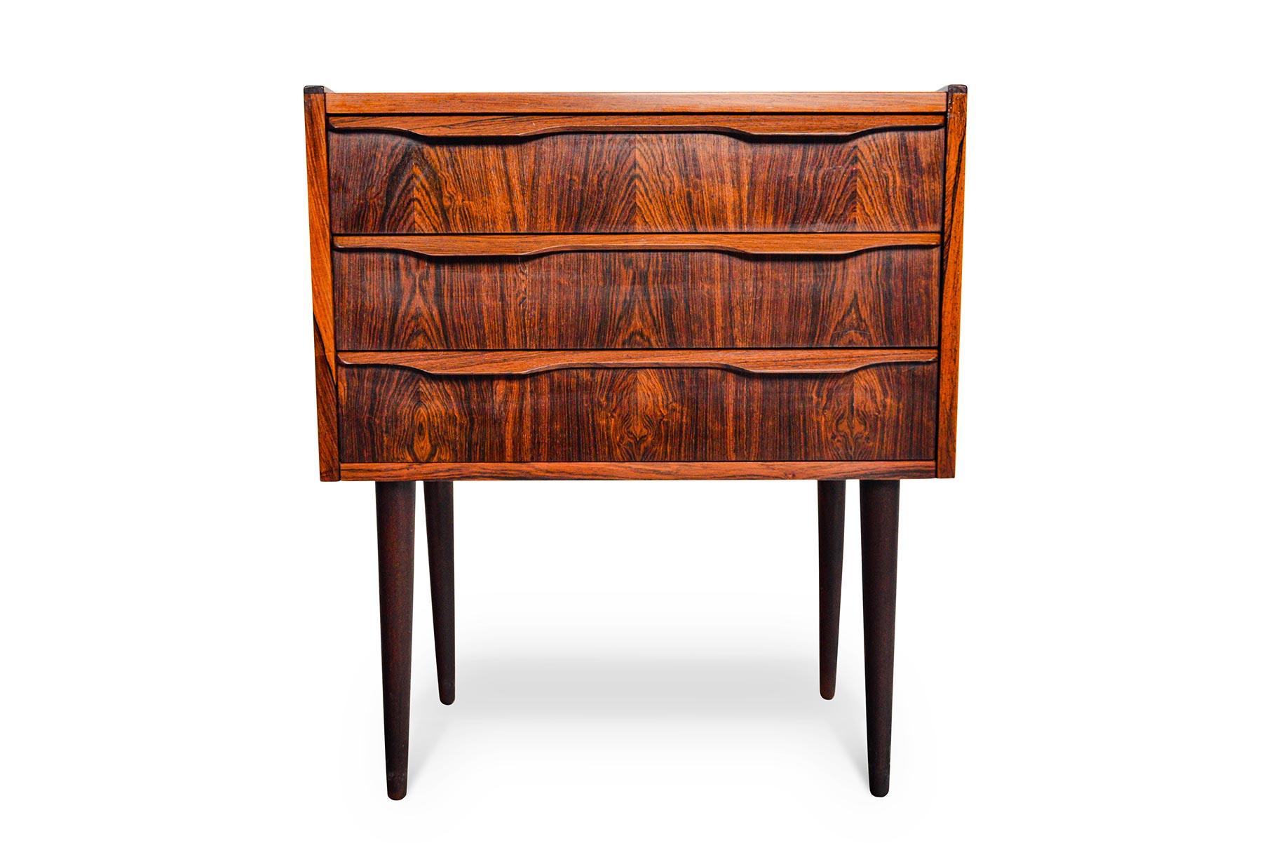 This Danish modern three-drawer Brazilian rosewood chest is perfect for any hallway, bedside, or space in need of storage! Three drawers with quarter profile pulls offers excellent storage. In excellent original condition.

  