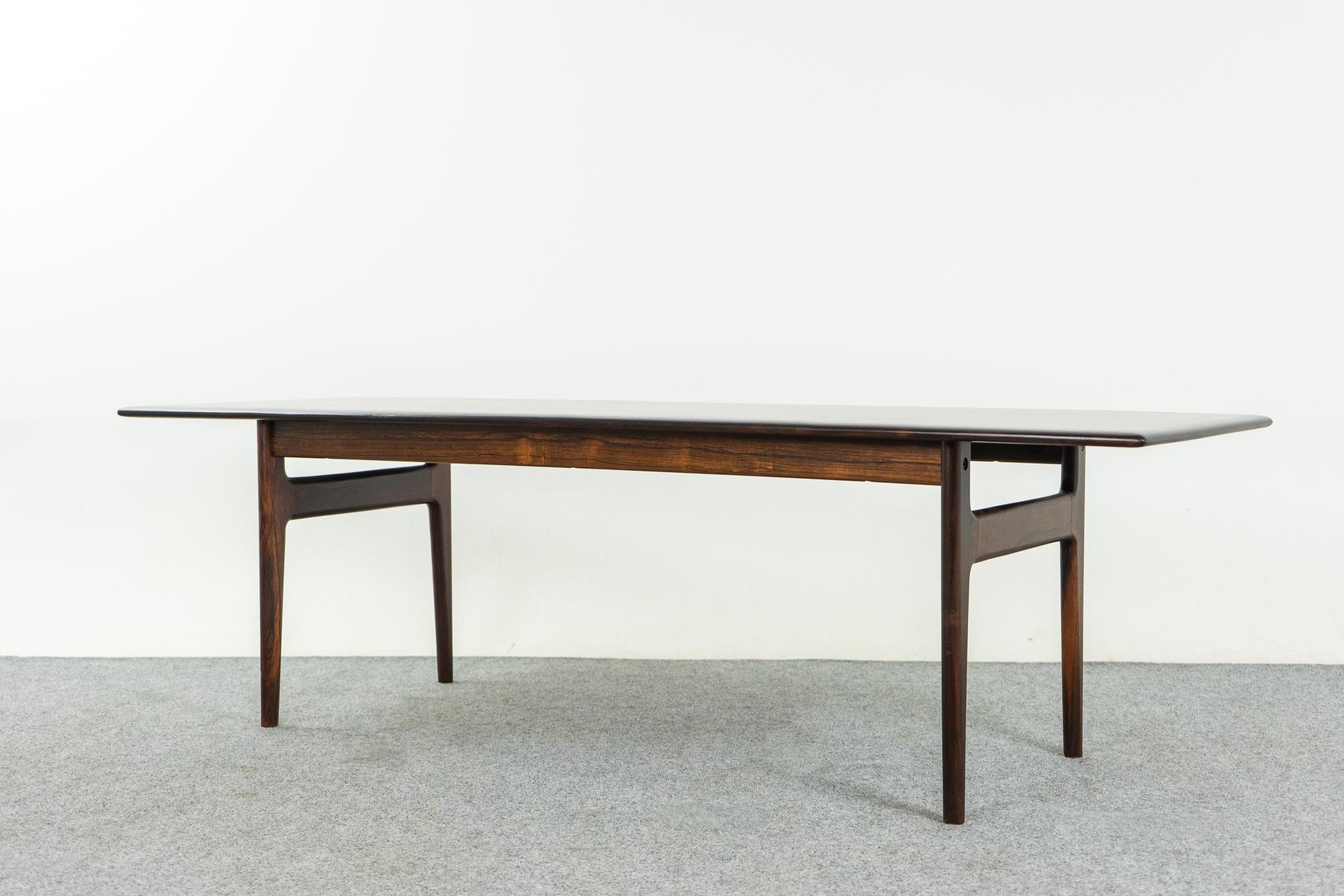 Rosewood Danish coffee table by Johannes Andersen for CFC Silkeborg, circa 1960's. Beautiful book matched veneer on the top, solid wood curved edges along its length. CFC Silkeborg makers mark medallion intact. Stature!

Please inquire for
