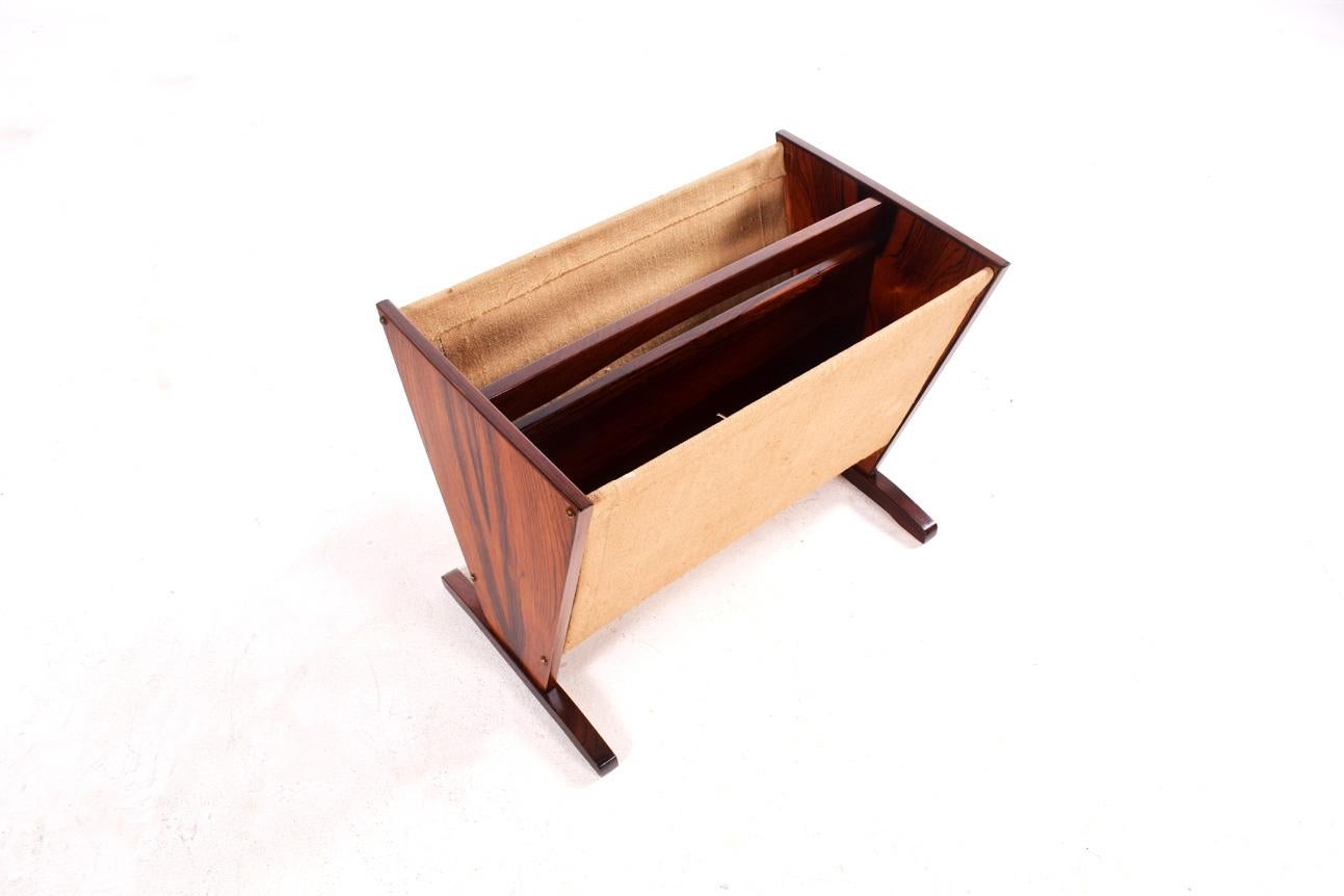 This lovely Danish rosewood magazine rack has a unique style. Dual space. Rosewood frame and cotton canvas sides. These are great for storing laptops, as well as magazines and books.