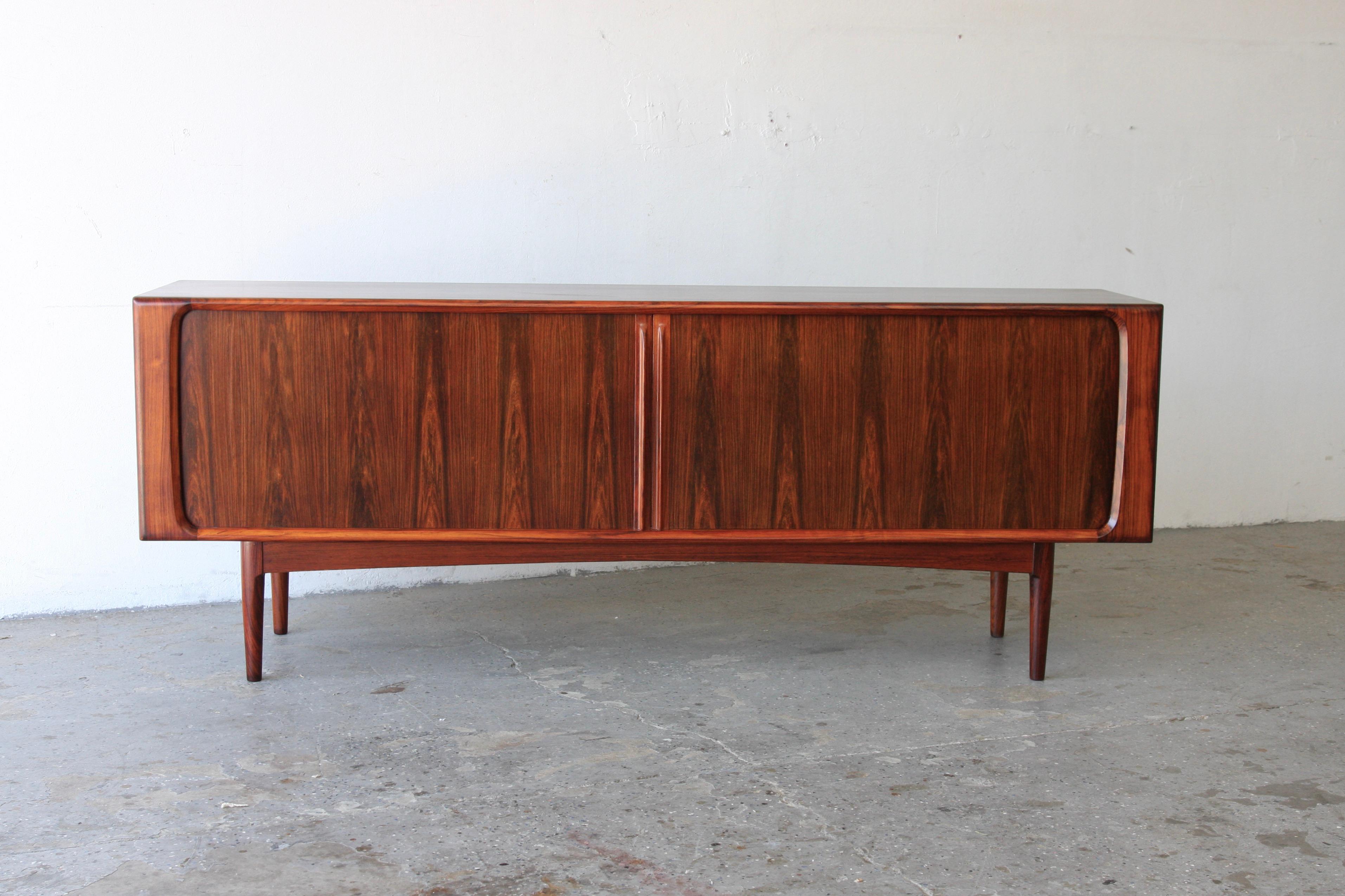 Exquisite Danish Mid-Century Modern Rosewood Credenza by Bernhard Pedersen & Son

Stunning mid-20th century rosewood credenza, masterfully crafted by the renowned Bernhard Pedersen & Son. This piece showcases smooth, swooping, sculpted cuts of