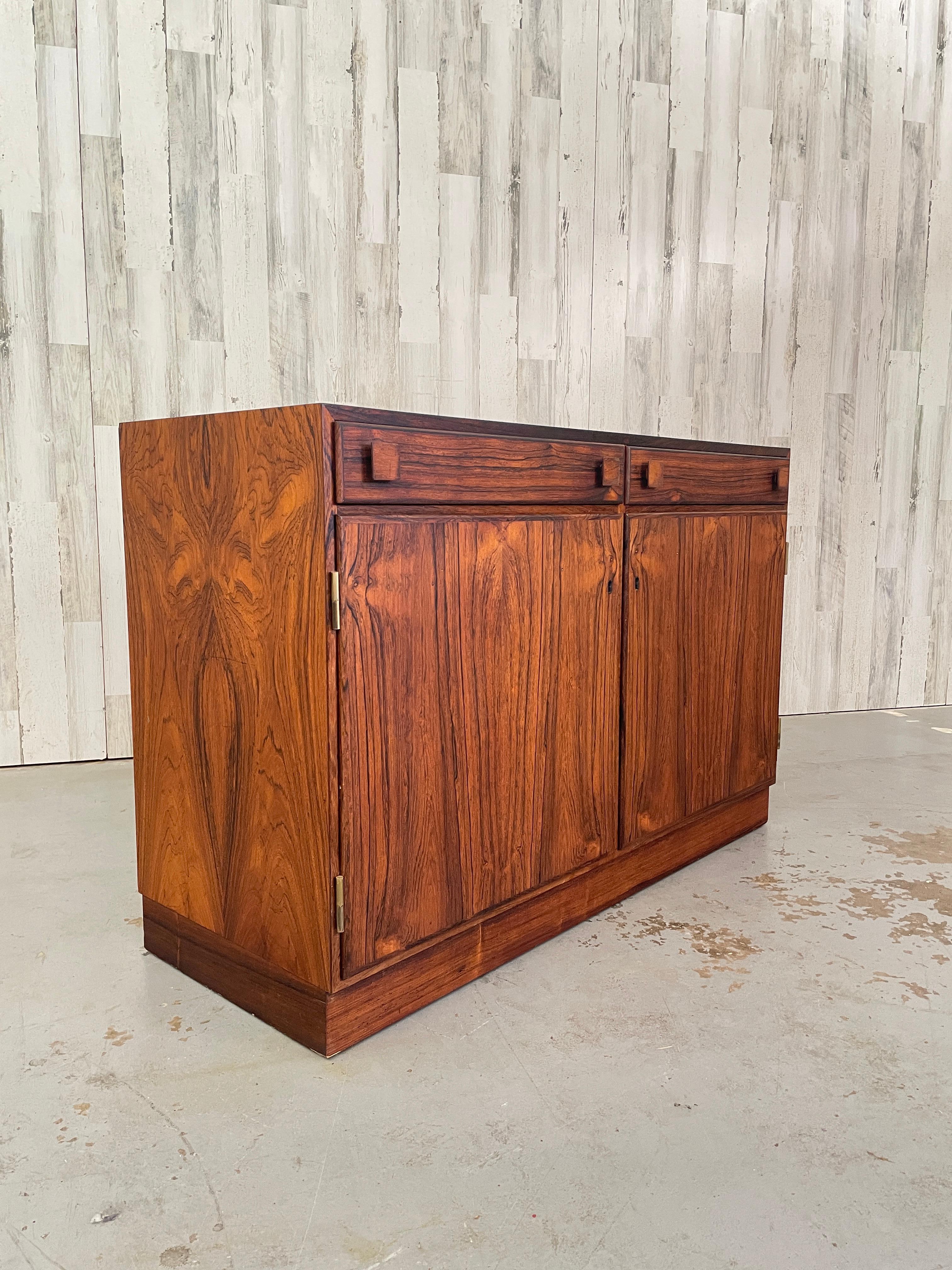 Petit rosewood Danish Modern cabinet with two drawers over two doors perfect for entry way.