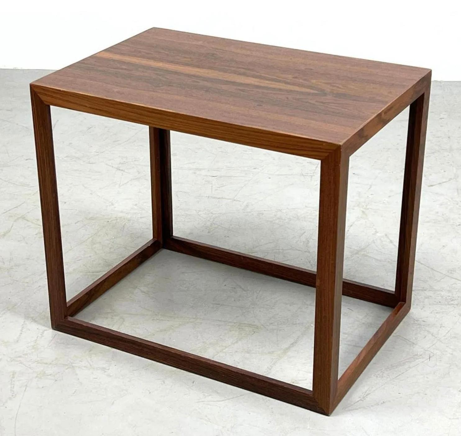 Danish modern rosewood table in the shape of an open cube. 

This side table is a work of fine material and craftsmanship with a unique geometry and symmetry. The top is a beautiful cut of rosewood with two book-matched panels, and the overall solid
