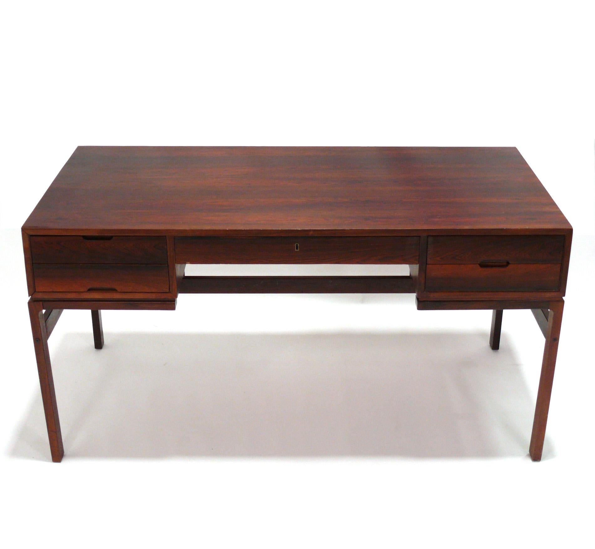 Clean Lined Rosewood Desk, designed by Arne Wahl Iversen for Vinde Mobler, Denmark, circa 1960s. This desk is currently being refinished and the price noted includes refinishing. This desk is finished and offers additional storage on the back side,