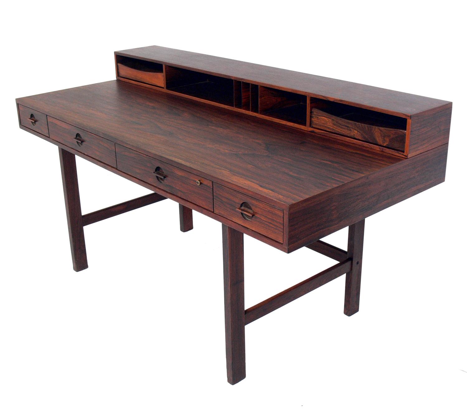 Clean lined architectural desk, designed by Jens Quistgaard for Lovig Dansk, Denmark, circa 1960s. It is an ingenious design as the top portion can be used as storage, or can be flipped down to be used as a partners desk. The desk measures 28.75