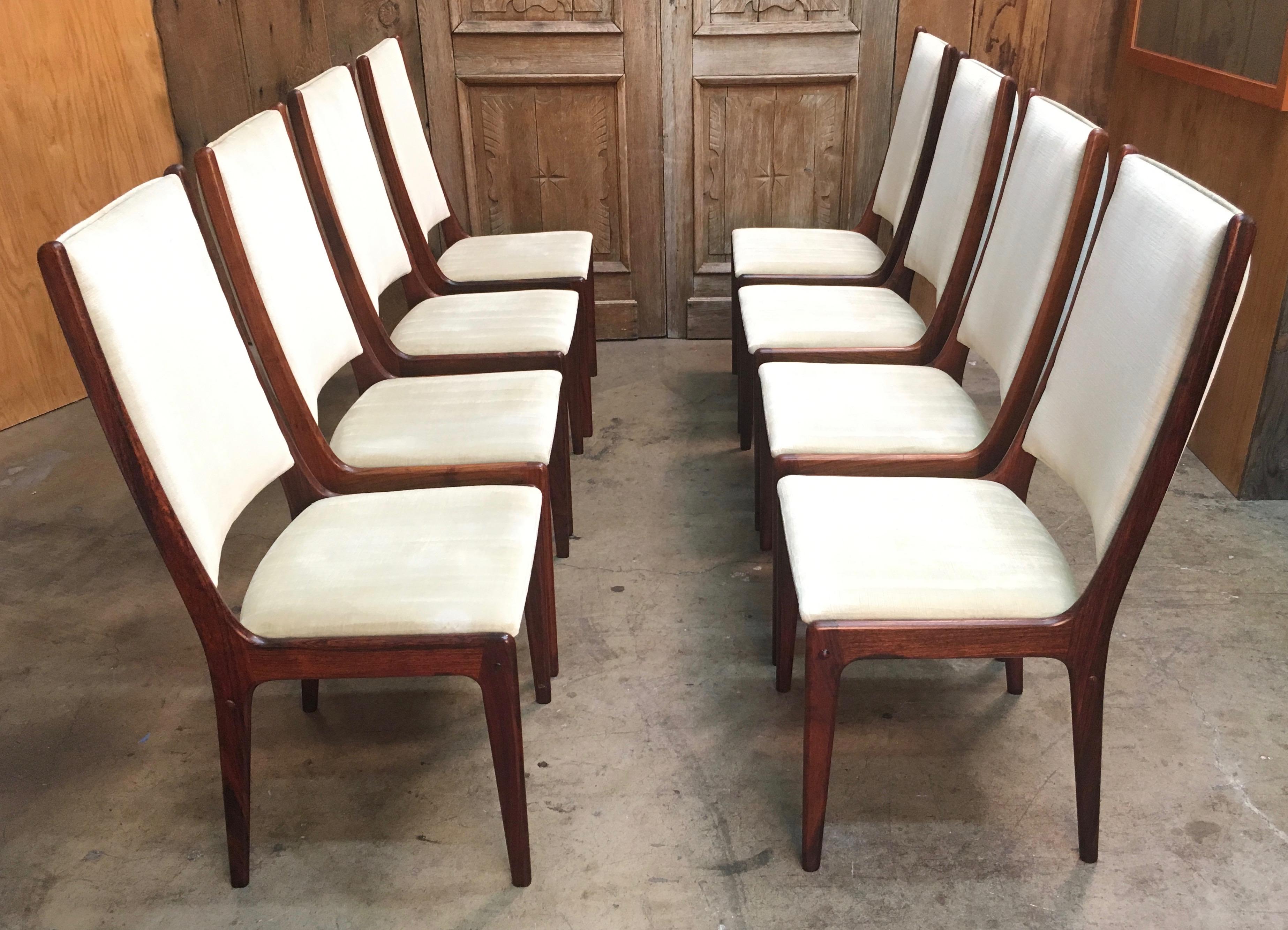Set of eight sculpted Danish modern rosewood high back dining chairs in the style of Johannes Andersen table not included.