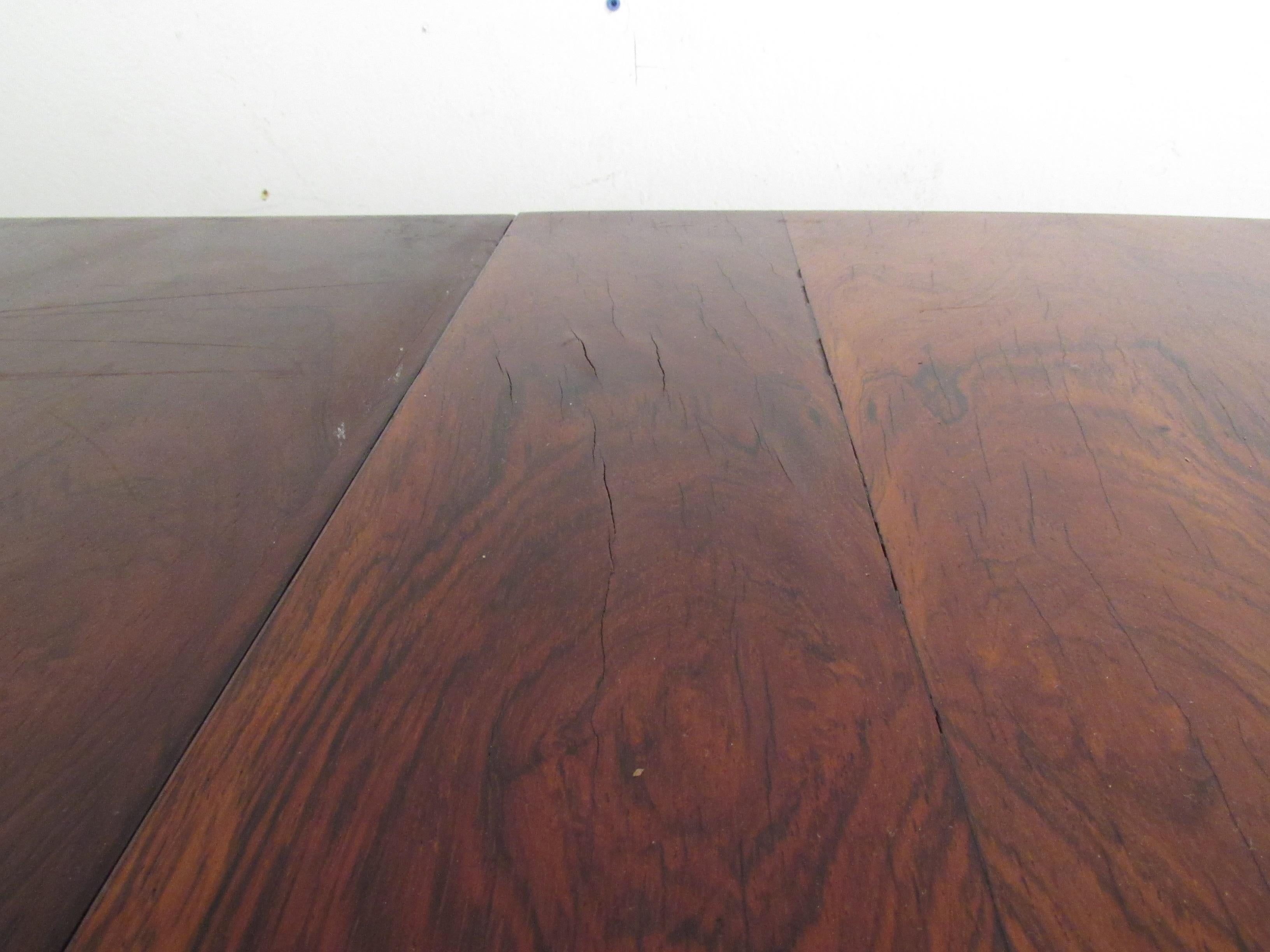 Vintage rosewood dining table with three leaves. The table with leaves (11.75