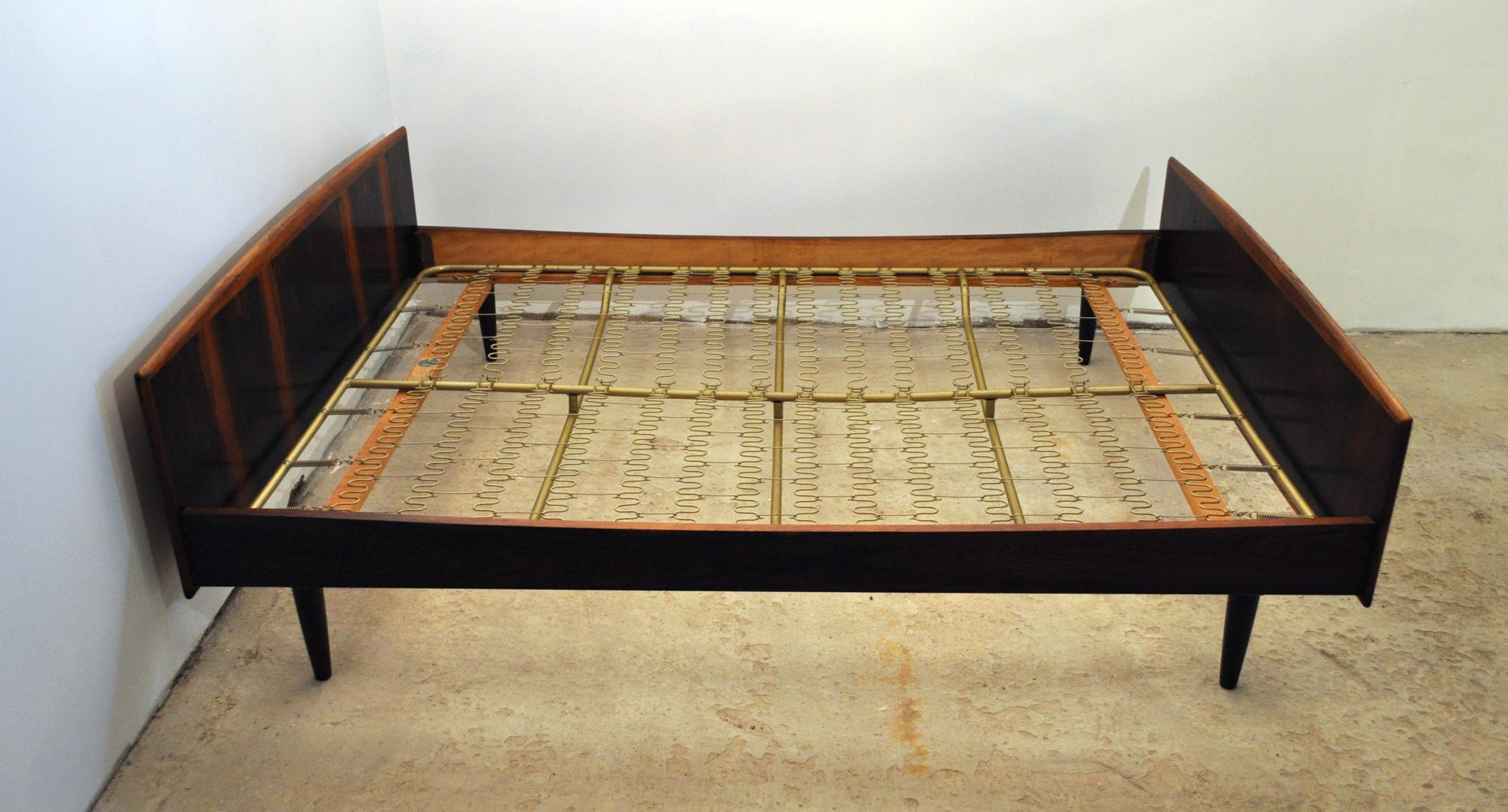 Danish modern rosewood double bed by Danish Sannemann, 1960s. Original label and numbered on the frame. 

Very good condition with few signs of wear consistent with age and use.

Measures: 
Height 64 cm
Length 190 cm
Width 140 cm.