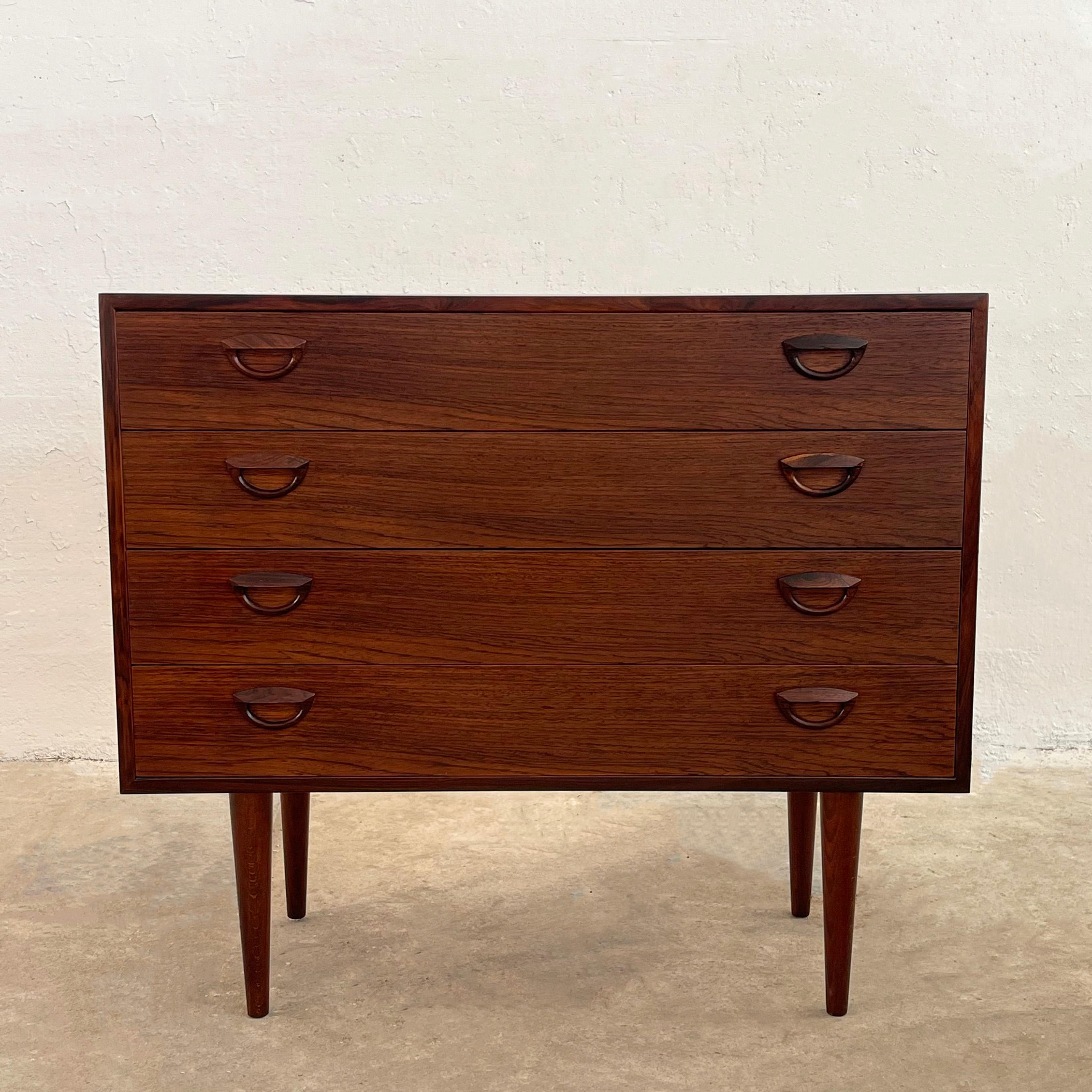Petite, Danish modern, rosewood dresser by Kai Kristiansen for Feldballes Møbelfabrik features four drawers at 4 inches height with signature eyelid pulls and beautiful rosewood grain throughout. 