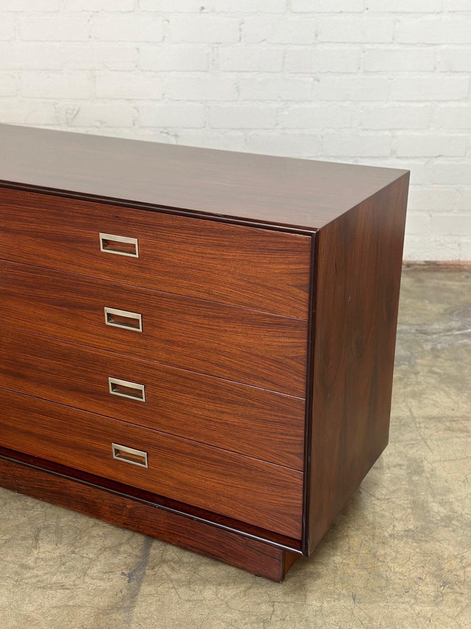 W64 D18.5 H29

Vintage rosewood dresser in fully restored conditon. Item is structurally sound and is fully functional. Dresser sits on a plinth base for great stability. Item has orginal recessed hardware and shows no major areas of wear. 

