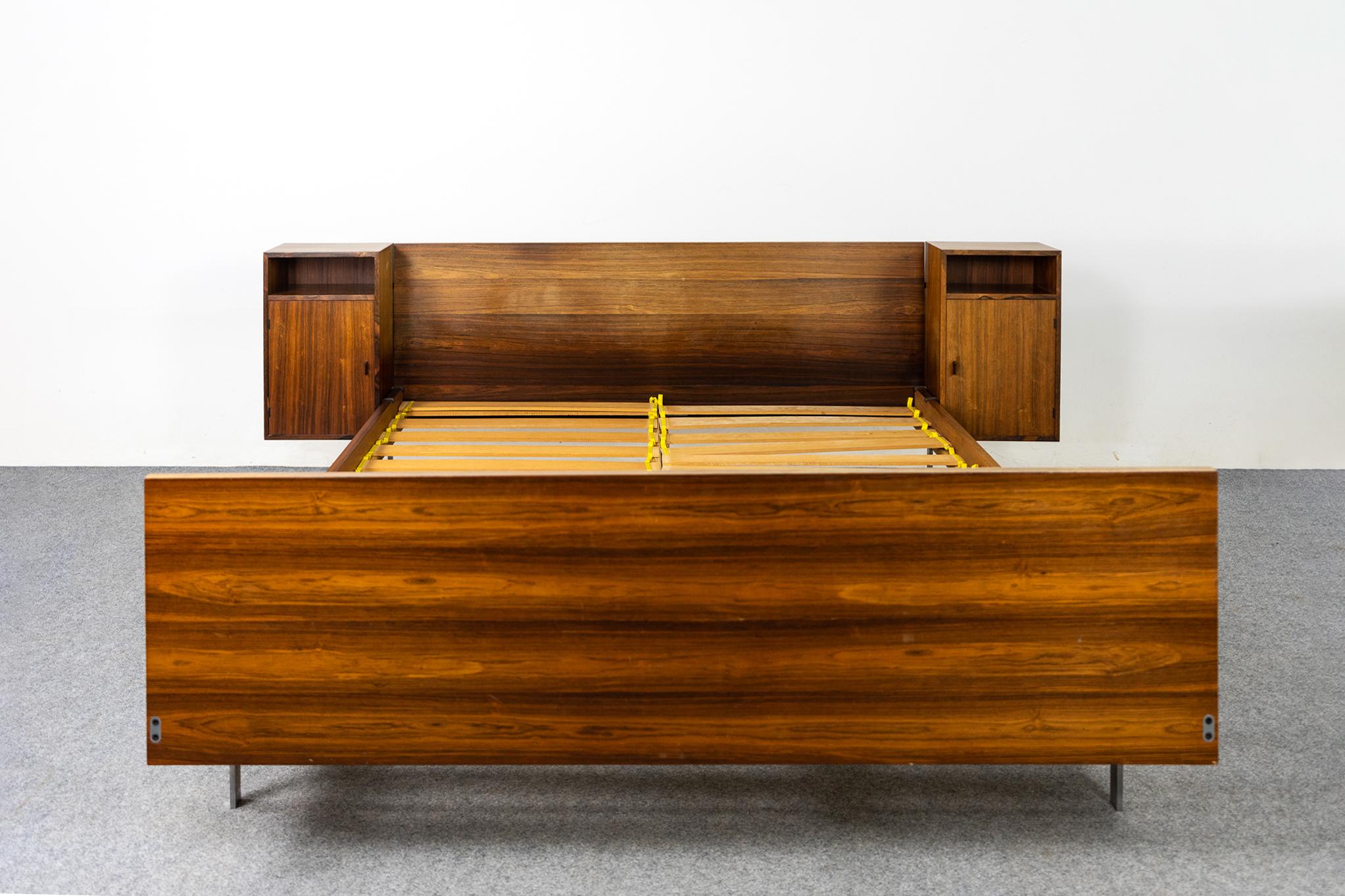 Rosewood *European queen size bed frame, circa 1960's. Impressive headboard with expertly book-matched veneer, floating night tables and chrome legs. Original hardwood slats, center support beam provides extra stability and comfort underneath your