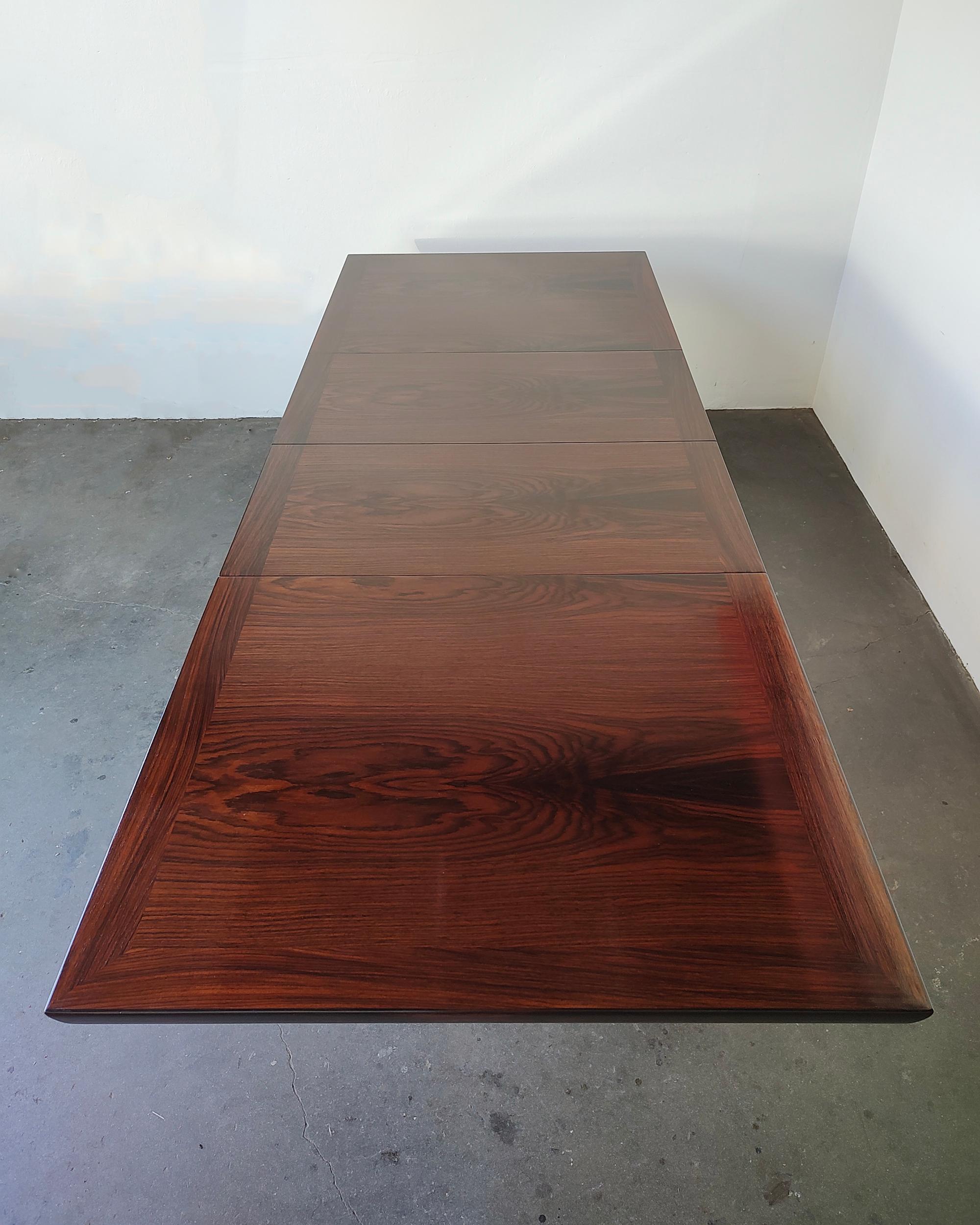 Gorgeous restored mid-century modern expanding rosewood dining table by Skovby Mobelfabrik Danish Control. Two leaves expand the table from 64.75
