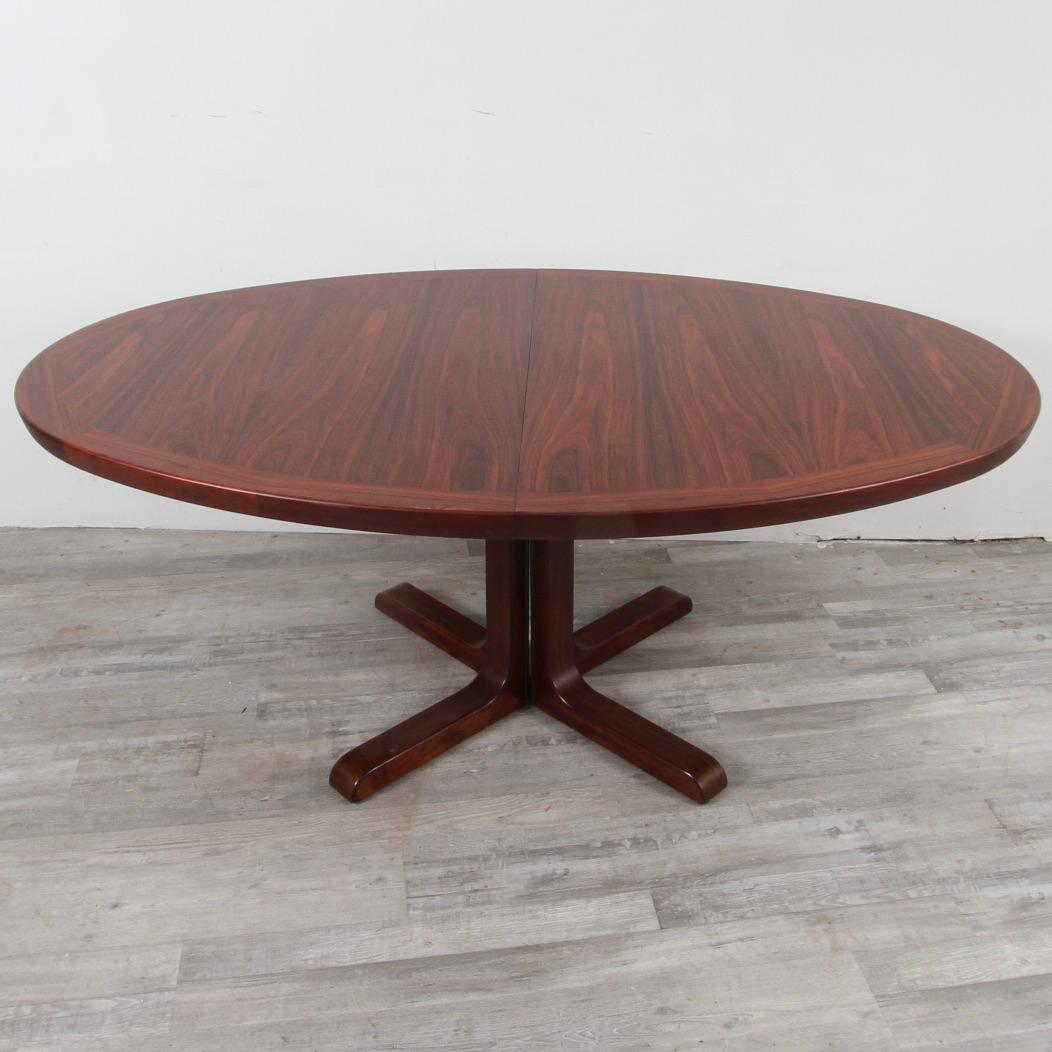 Just refinished expandable rosewood dining table by Danish furniture maker Skovby. This oval dining table opens from 71 inches to 110 inches wide with both leaves in place, comfortably seating 8.