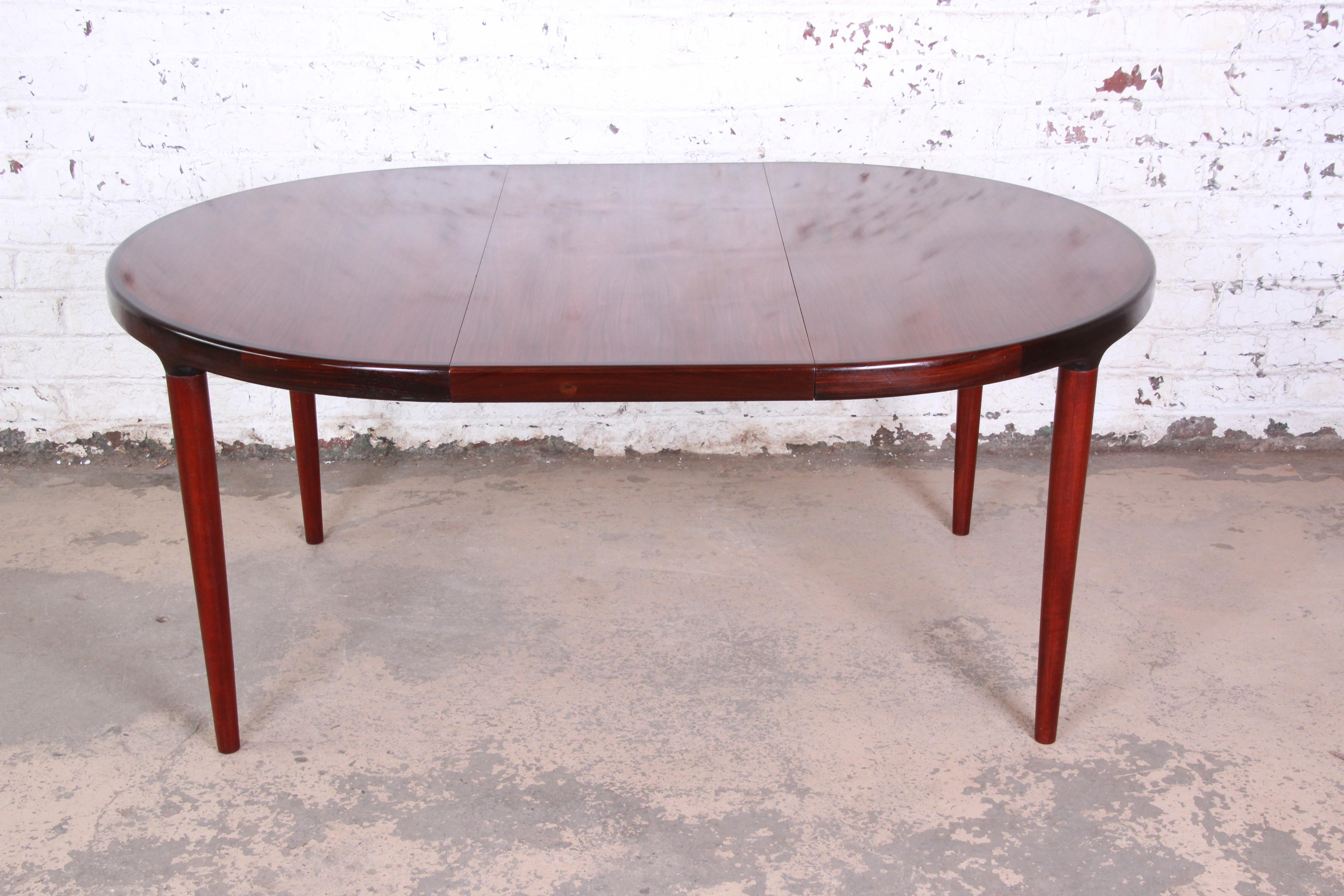 A great Danish modern rosewood extension dining table. The table includes one leaf that measures 19.65