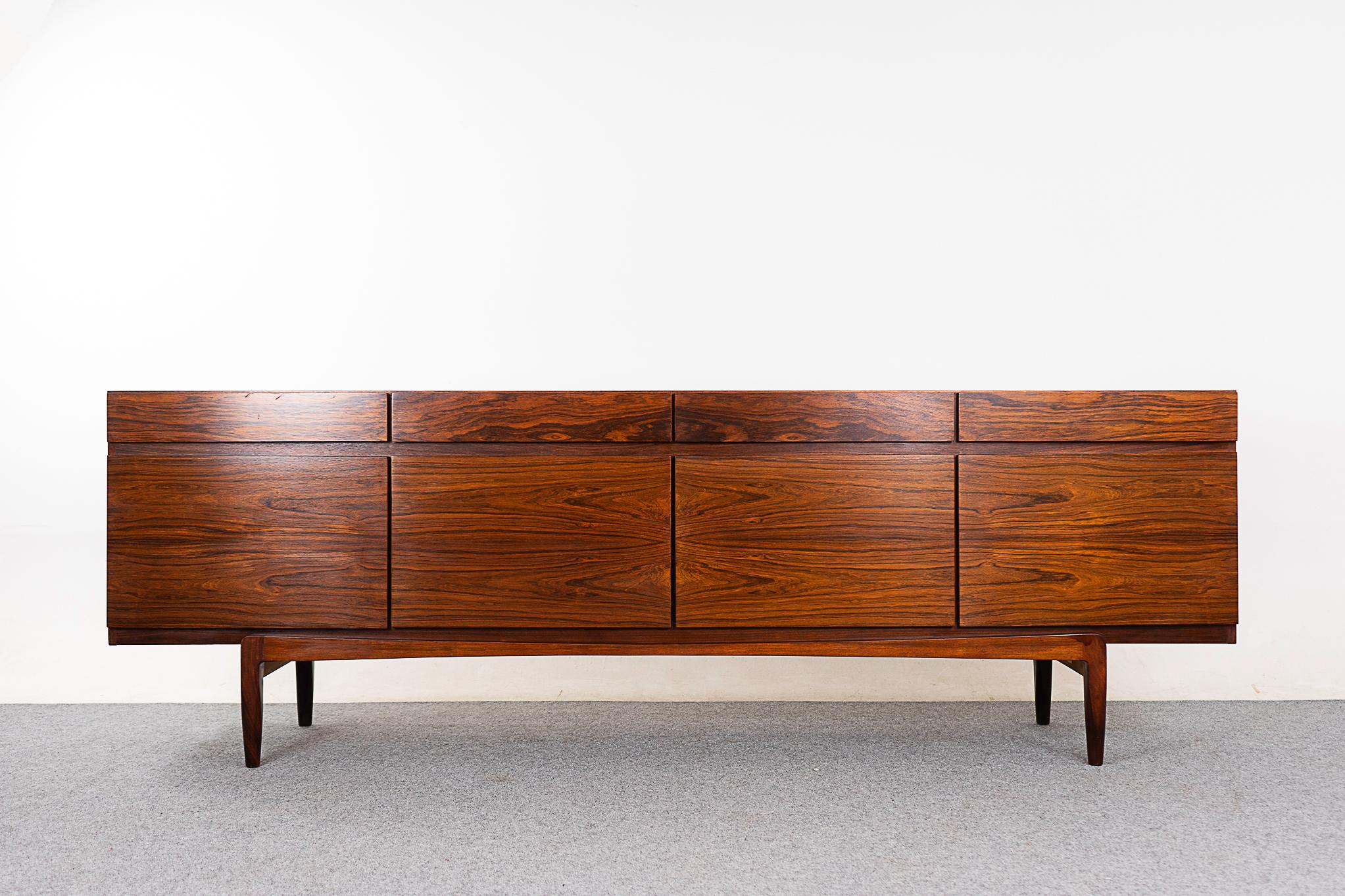 Rosewood model Fa-66 sideboard by Ib Kofod Larsen for Faarup Mobelfabrik, circa 1960's. Substantial, sleek, minimalist design with exquisite book-matched veneer! Ample adjustable shelving and a bank of felt lined interior slim drawers with mortise