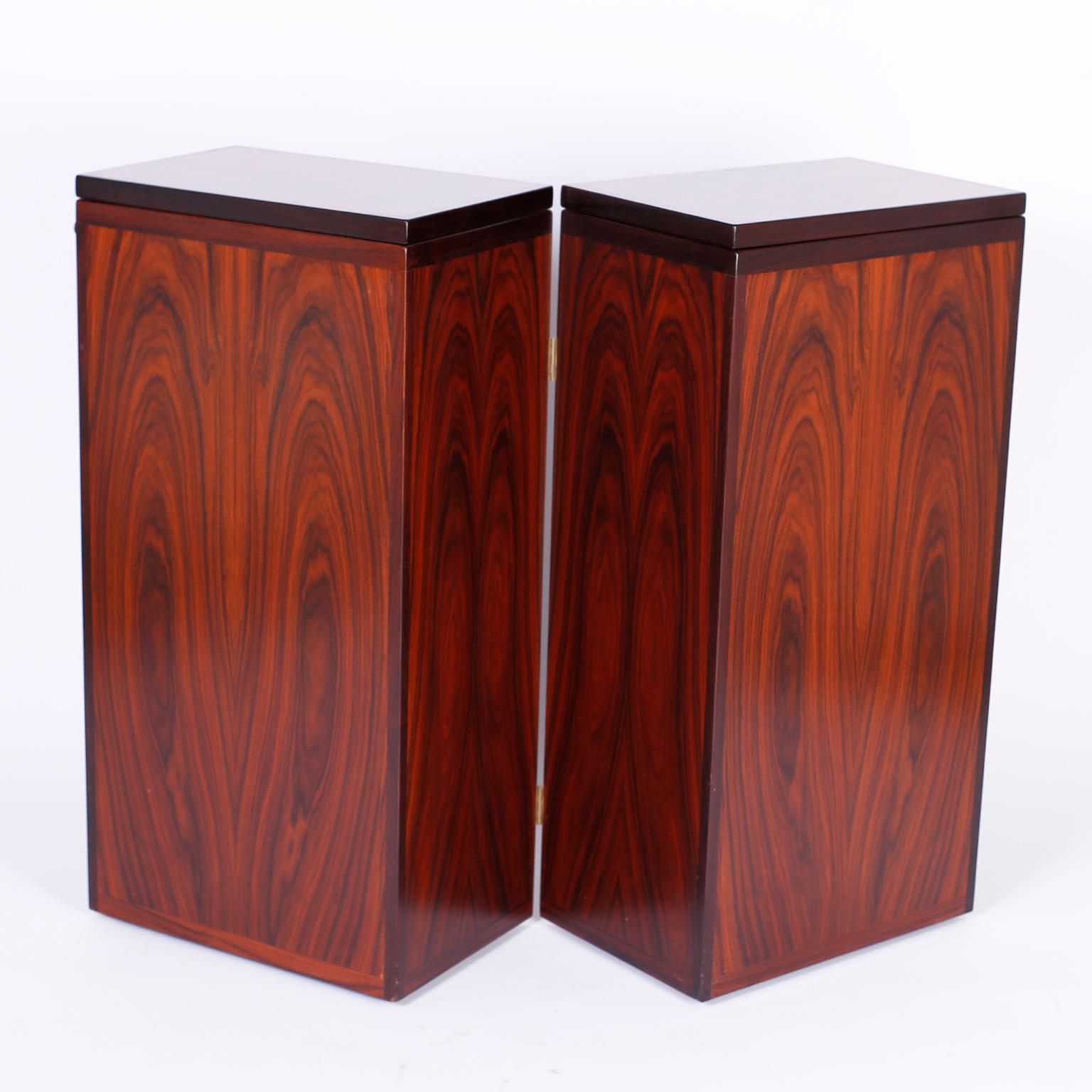 Well grained rosewood bar cabinet that opens to reveal a campaign style interior with plenty of storage and a fold out top service area. Designed by Reno Wall Iverson for Dyrlund, Denmark. 

Open width 36
Fold out top width 72.
