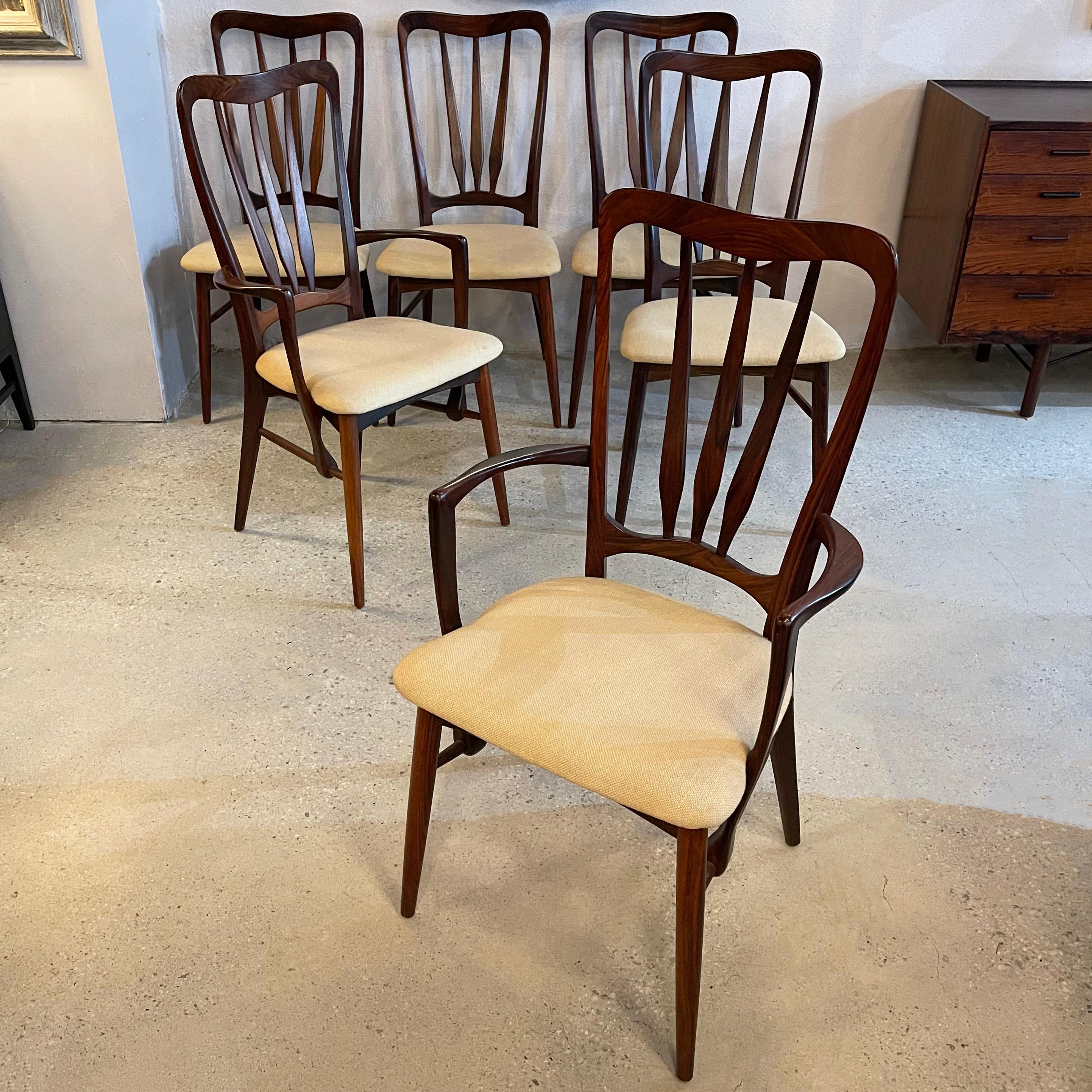 Set of six, Danish modern, rosewood, “Ingrid” dining chairs by Niels Koefoed for Koefoeds Hornslet consists of four side chairs and two captain armchairs. The curvaceous frames feature high backs with a deep rosewood grain throughout and subtle