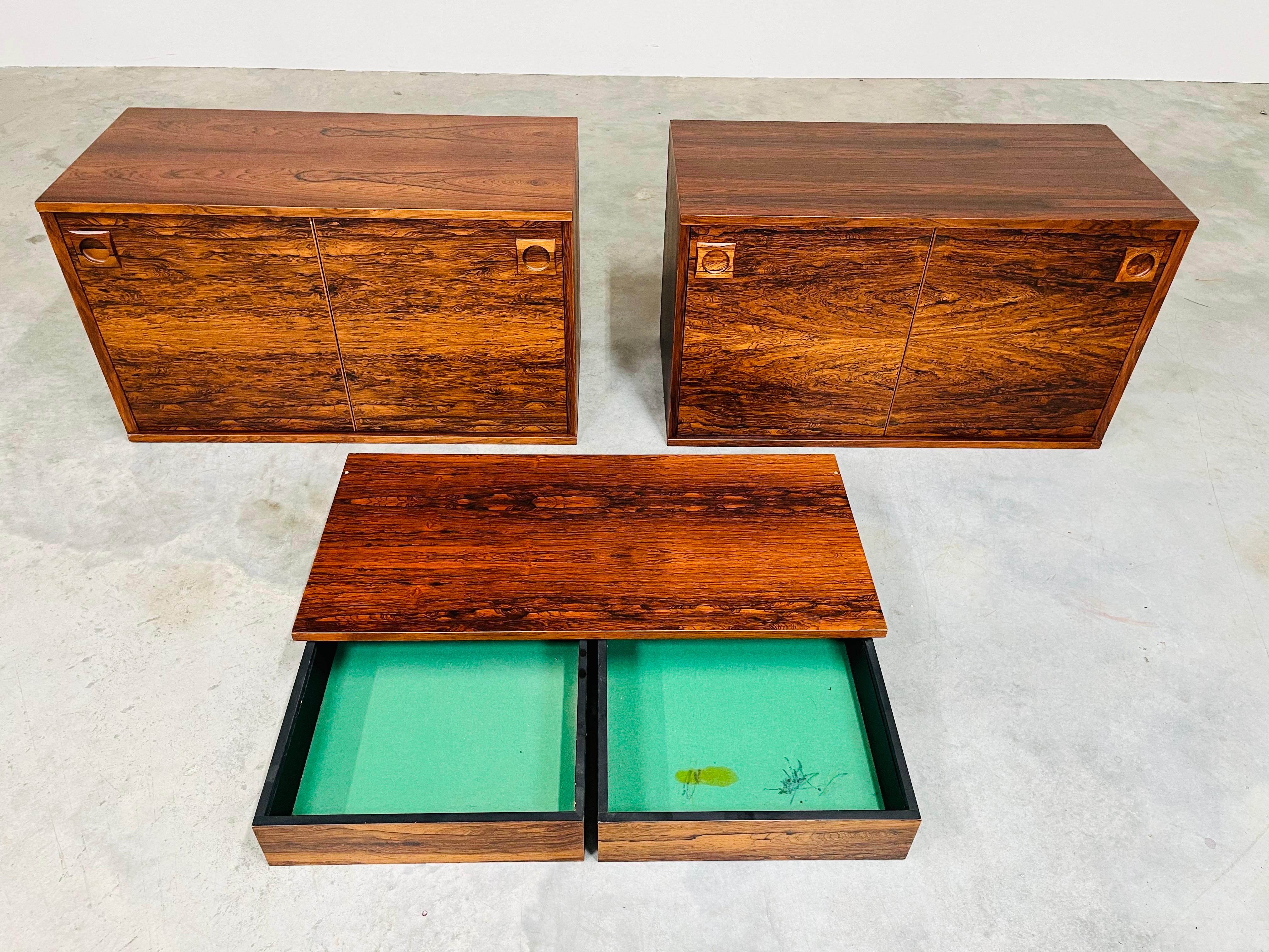 A beautiful 3 piece rosewood cabinet and hanging desk set to ad to your wall unit or create your own single row setup. Features 2 matching spring push-in sliding doors with removable rosewood shelves on both sides and a 2-drawer wall hanging desk.