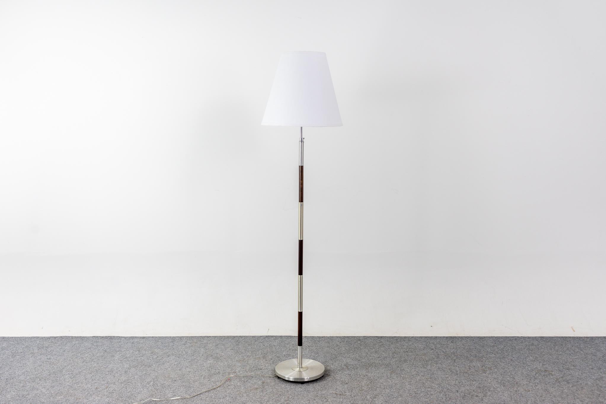 Rosewood and metal Danish floor lamp, circa 1960's. Beautiful solid rosewood construction with metal accents. New custom fabric shade. Tri-light fixture and new wiring.

Please inquire for remote and international shipping rates.