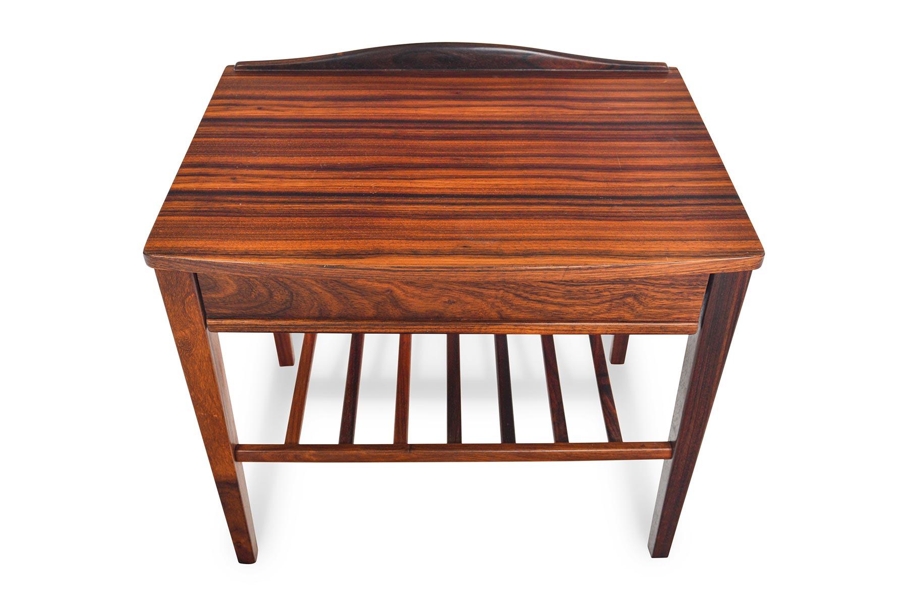 This wonderful Danish modern midcentury nightstand is cased in rosewood but stands on a beautifully tapered base. Excellent for use as larger nightstand or entry chest, this well- crafted piece features a single drawer with divided storage and a