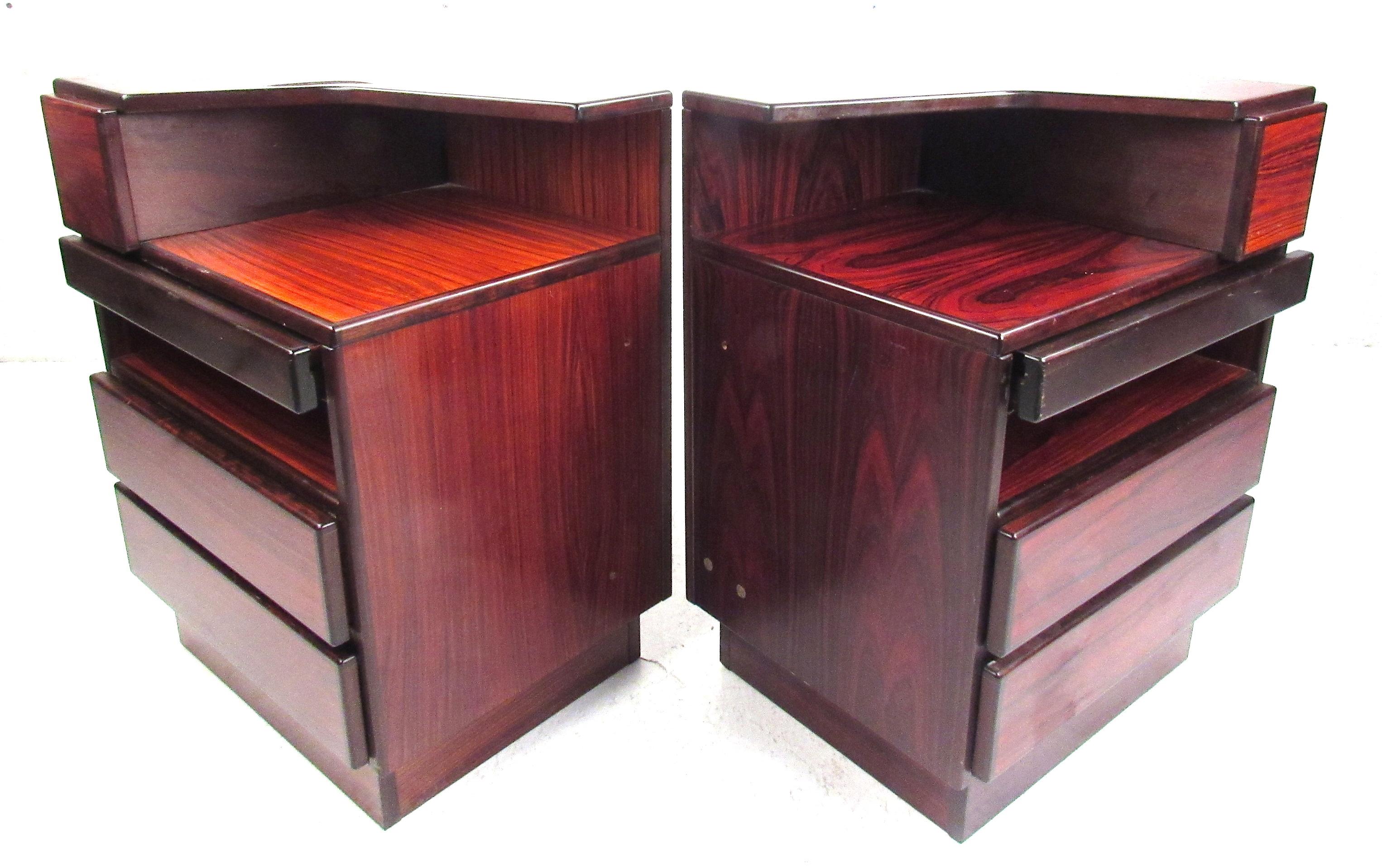 Versatile pair of rosewood nightstands featuring a small upper drawer with a pull-out shelf below, and two larger drawers at bottom. Marked ‘Scan Coll, Made in Denmark.’ Please confirm item location (NY or NJ) with dealer.