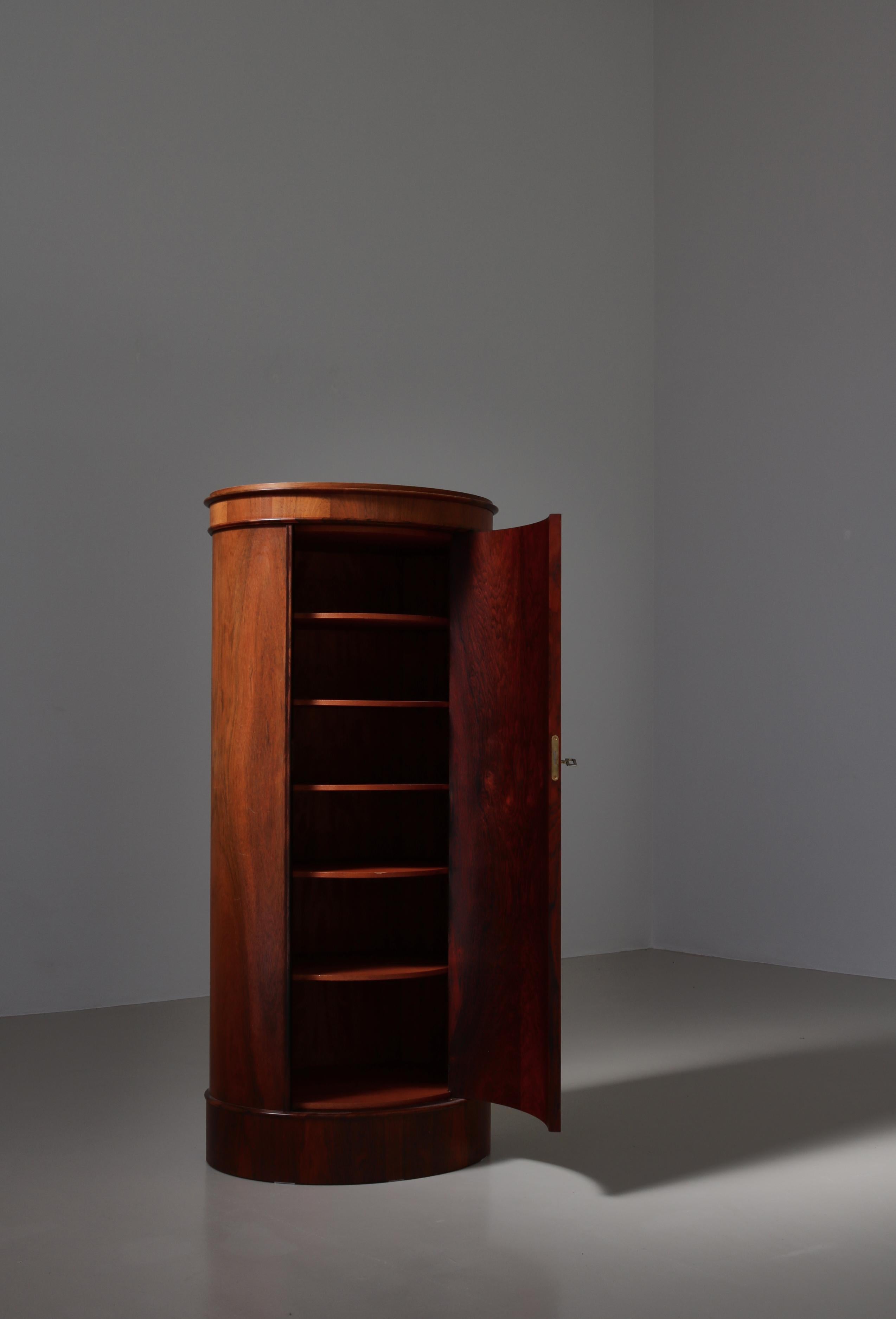 Rare and beautiful Danish Modern oval shaped rosewood pedestal cabinet 