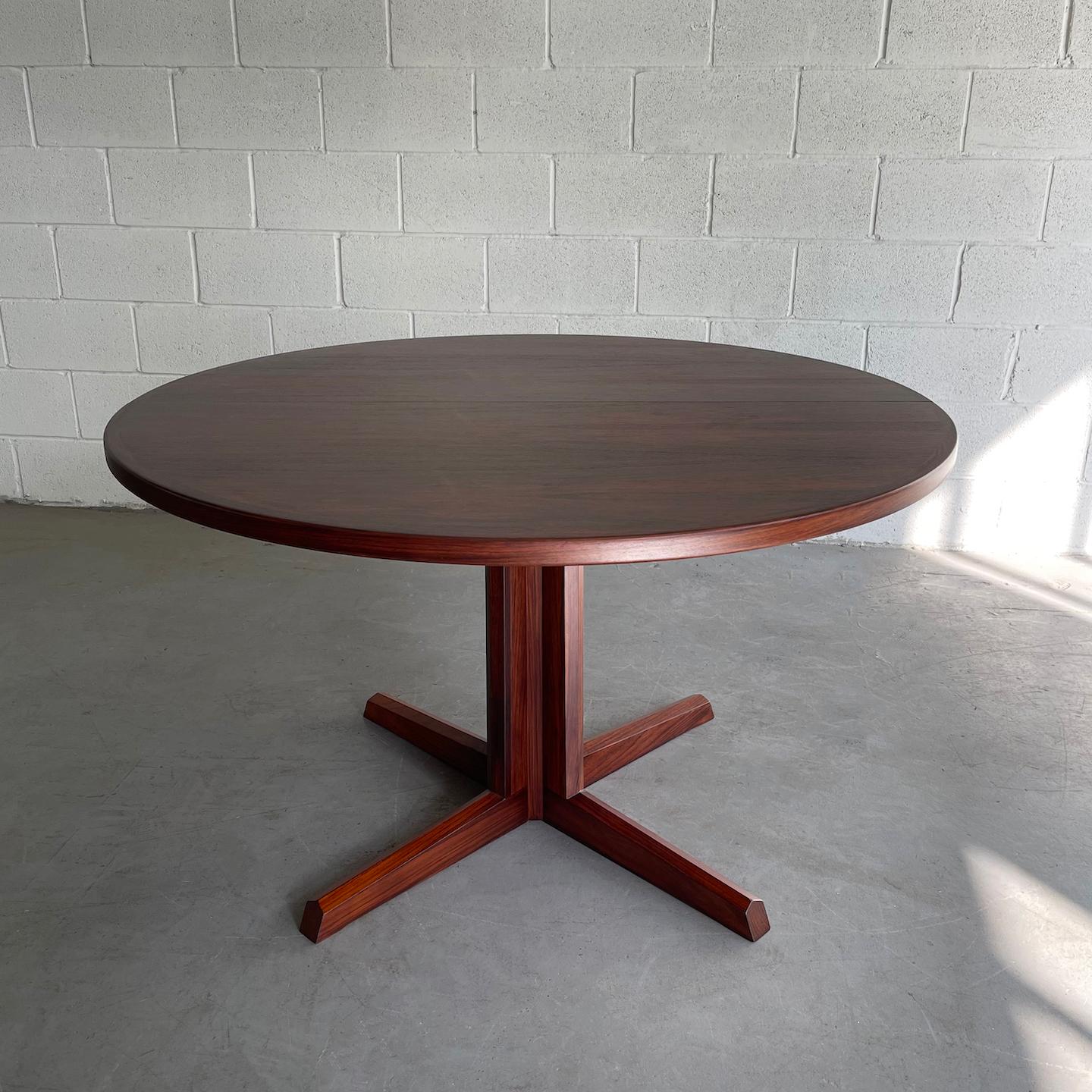 Nicely proportioned, Danish modern, round, rosewood, dining table features a pedestal base.