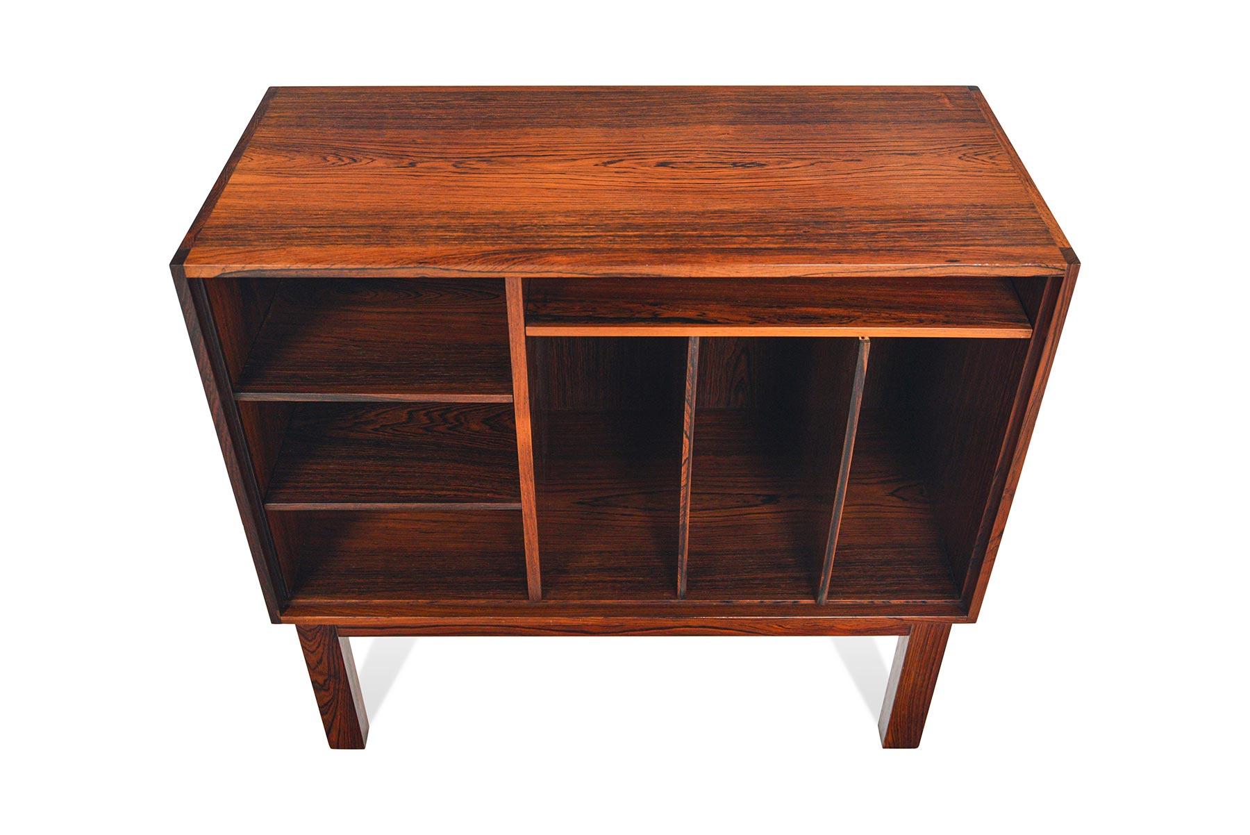 This Danish modern small Brazilian rosewood record storage cabinet is a sought after by midcentury collectors and audiophiles alike. Designed in the late 1960s, this fantastic piece features a large cubby with adjustable dividers- perfect for