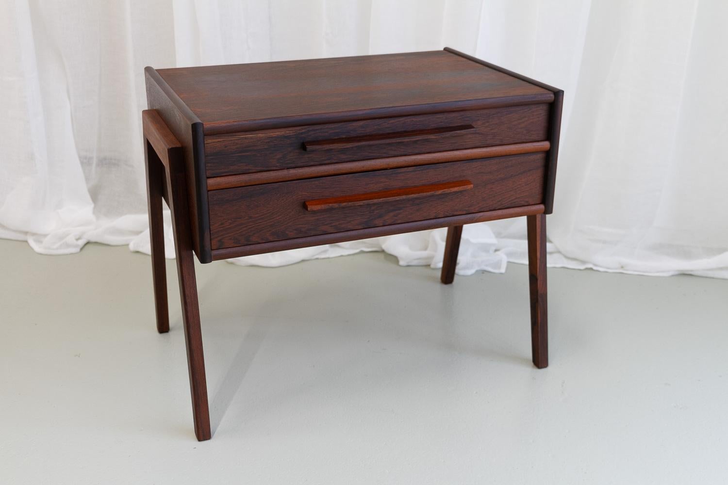 Danish Modern Rosewood Side Table, 1960s.
Stylish and versatile Scandinavian Mid-Century Modern Rosewood/Palisander table with two double sided drawers. Drawers has a light interior and top drawer features small compartments. Slanted and tapered