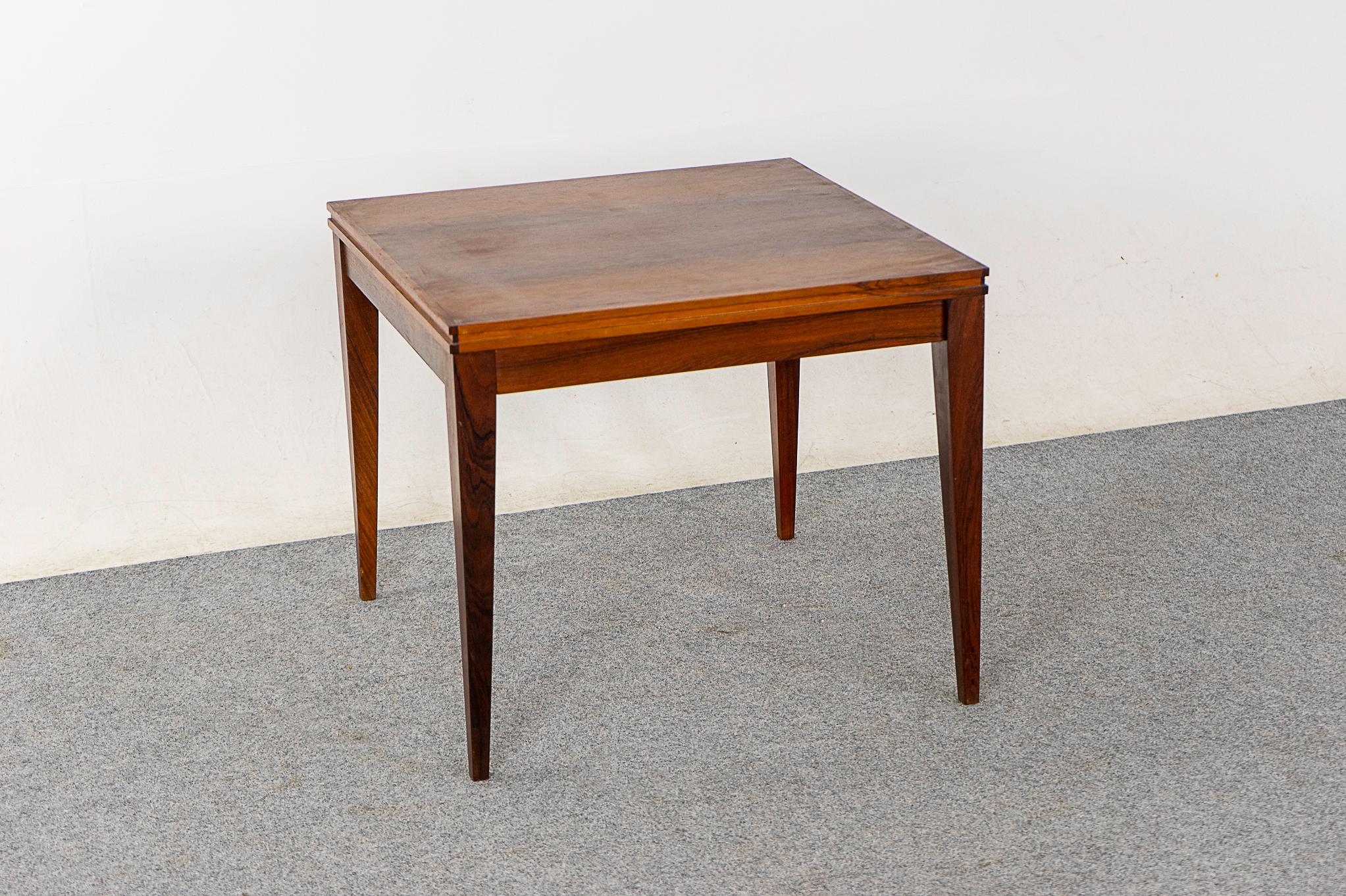 Rosewood mid-century side table, circa 1960's. Compact, highly functional table with slender tapering legs. Pairs perfectly with large sofas!

Please inquire for international and remote shipping rates.