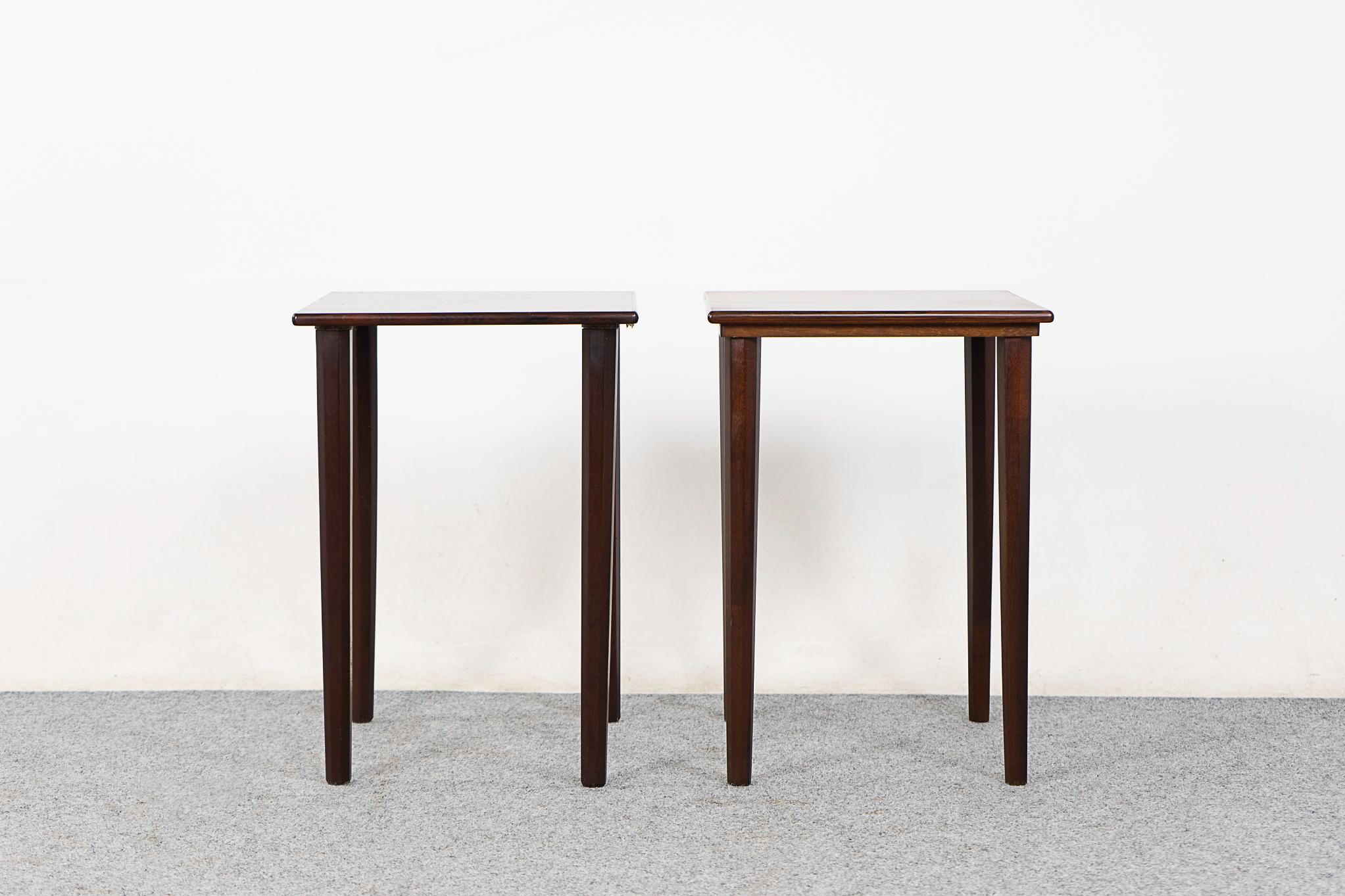 Rosewood side tables, circa 1960's. Long tapered legs and beautifully bookmatched veneer surfaces. Sleek!

Unrestored item, some marks consistent with age.