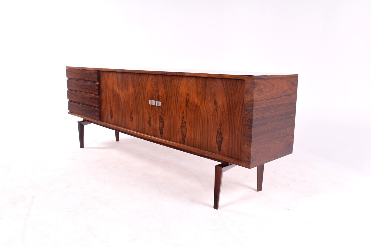 Danish sideboard H.W. Klein in rosewood for Bramin, with metal handles. Lovely sideboard with well balanced proportions and fine details with the handles falling underneath the drawers are evidence of excellent designed.