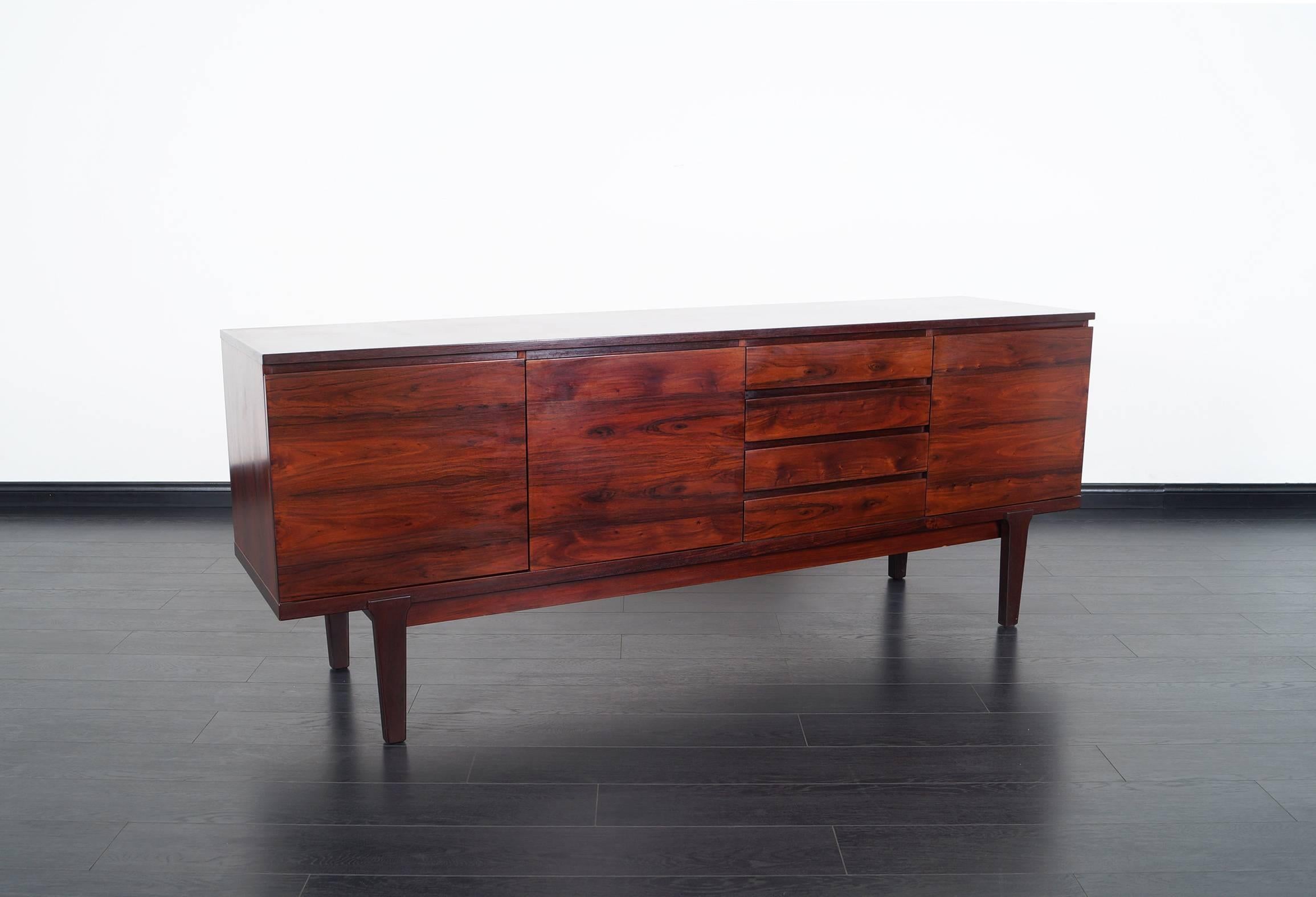 Danish modern rosewood sideboard manufactured in Denmark, circa 1960s. Features three adjustable shelves and a total of four dovetailed drawers.