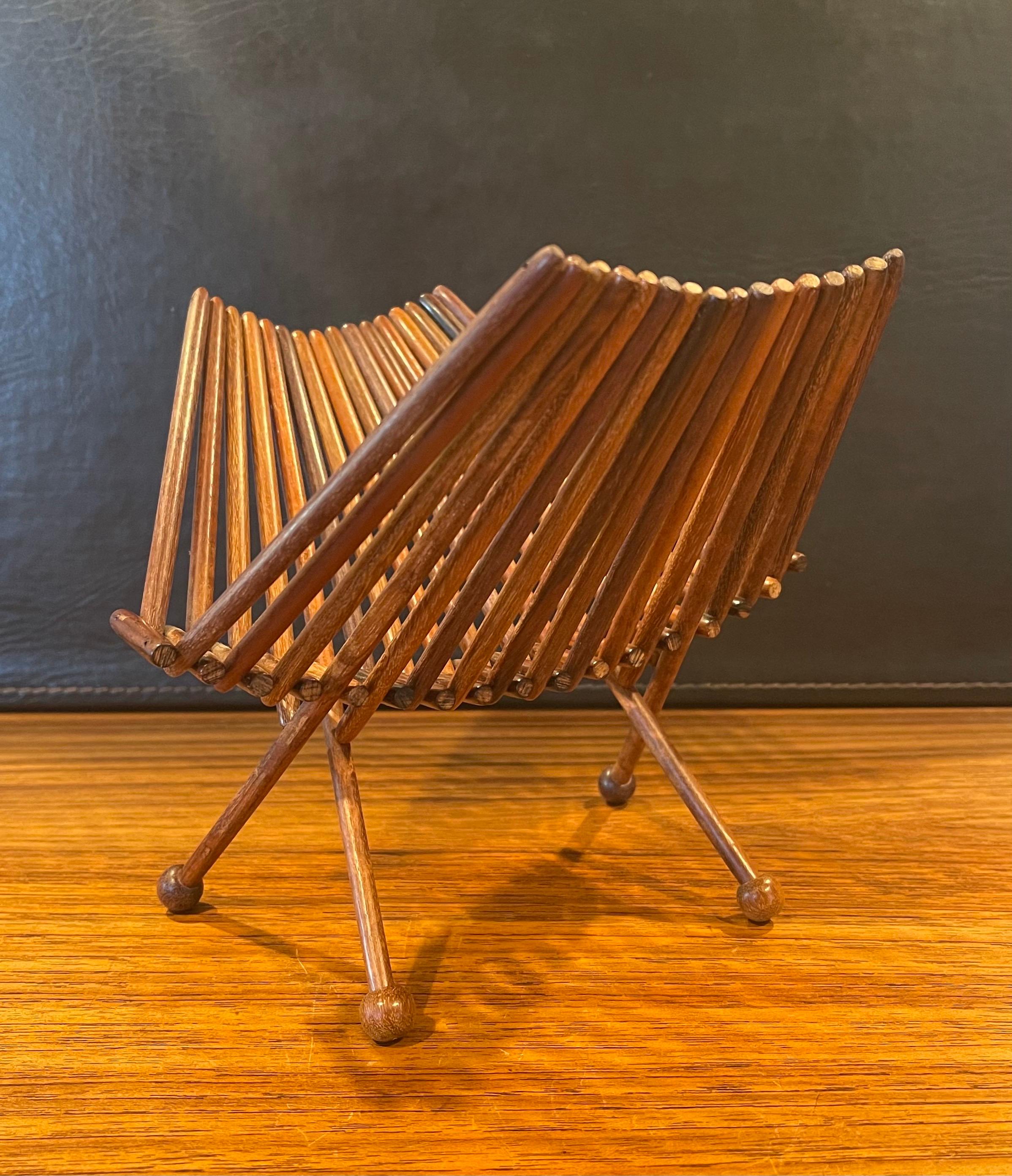 A very cool and unique Danish modern rosewood spindle napkin holder, circa 1960s. The piece is in very good vintage condition and measures 7.5