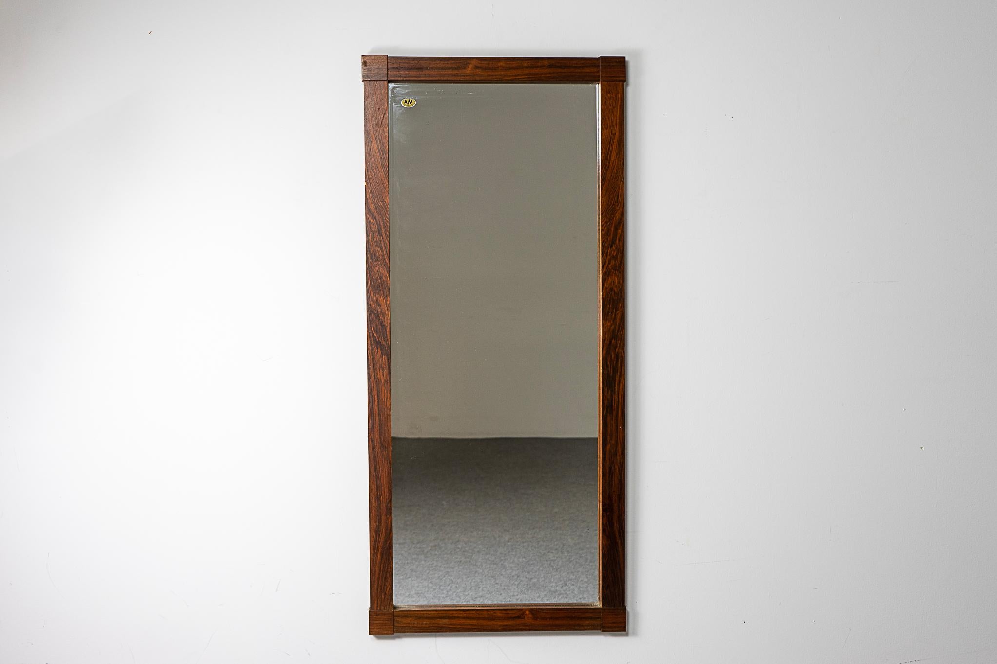 Rosewood Danish mirror, circa 1960's. Slim design with unique corners. Perfect dimensions for hanging near the door to check yourself before heading out.

Please inquire for international shipping rates.