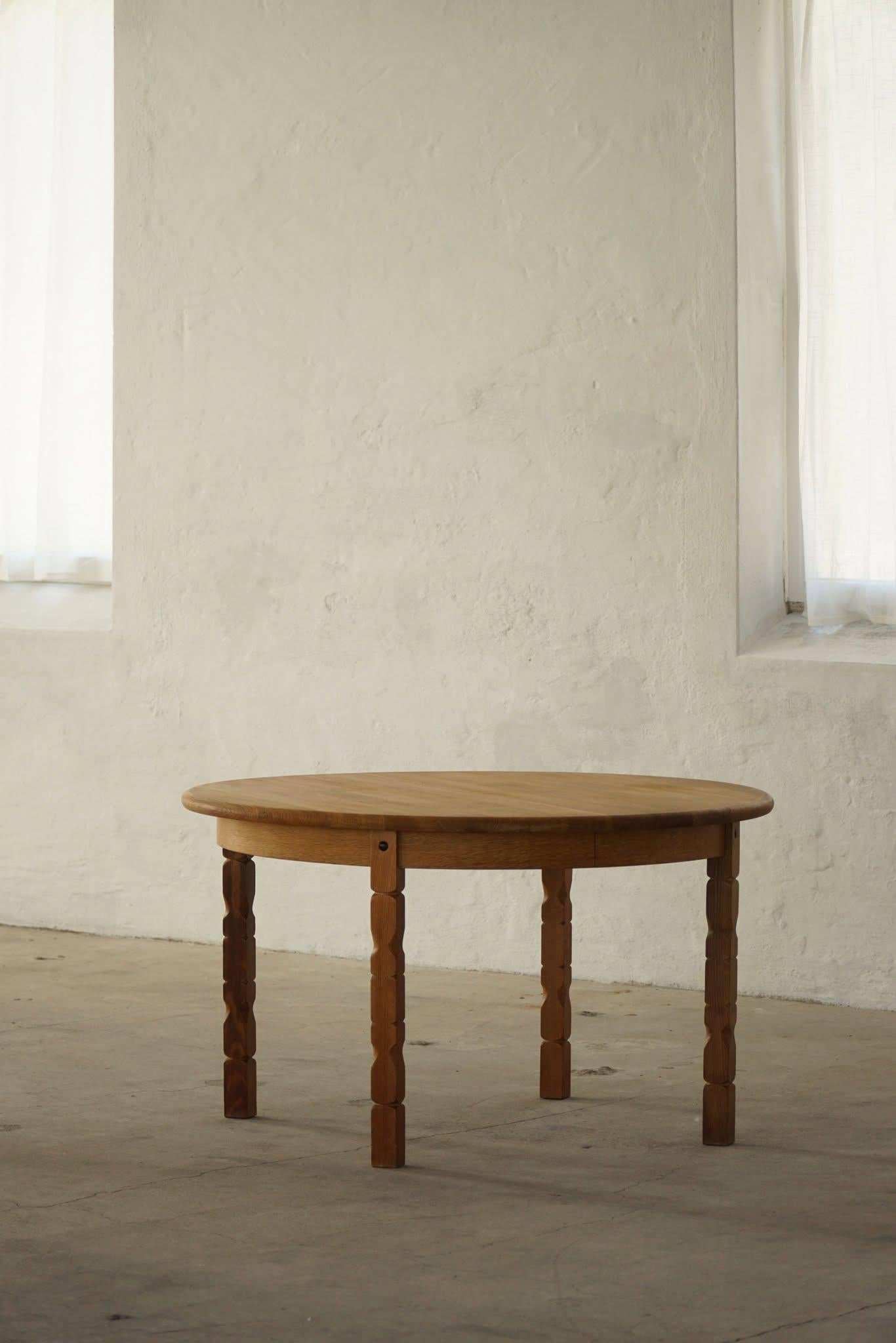 Classic round dining table in solid oak with two extensions, made in the 1960s by a Danish Cabinetmaker. Such a sculptural figure for the modern interior.

Curved legs and great craftmanship in this brutalist table.
Light signs of wear on the