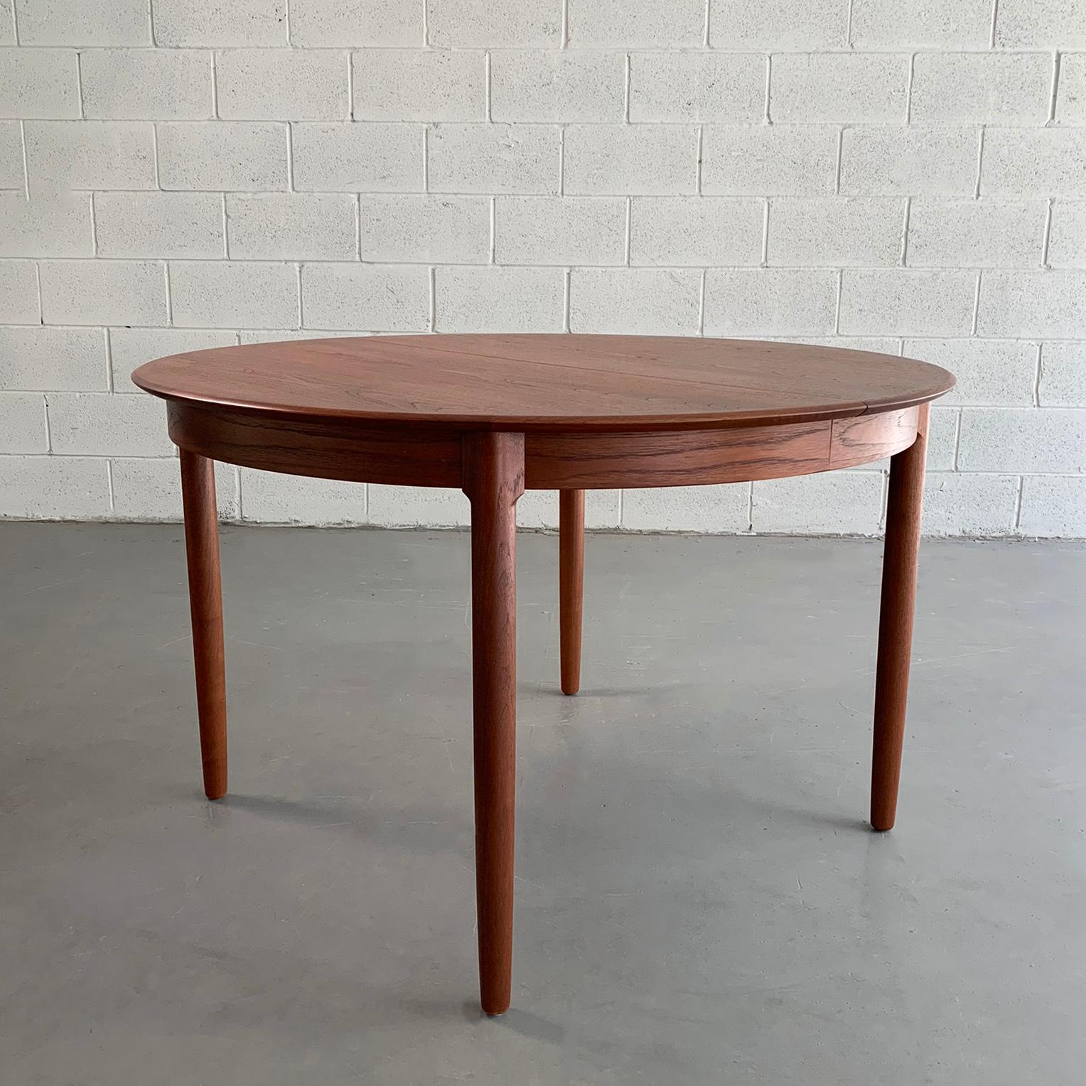 Beautifully detailed, Danish modern, 47 inch round, teak dining table features 2 leaves to extend to 67 inches with one leaf and 86.5 with both leaves to accommodate 8 people.